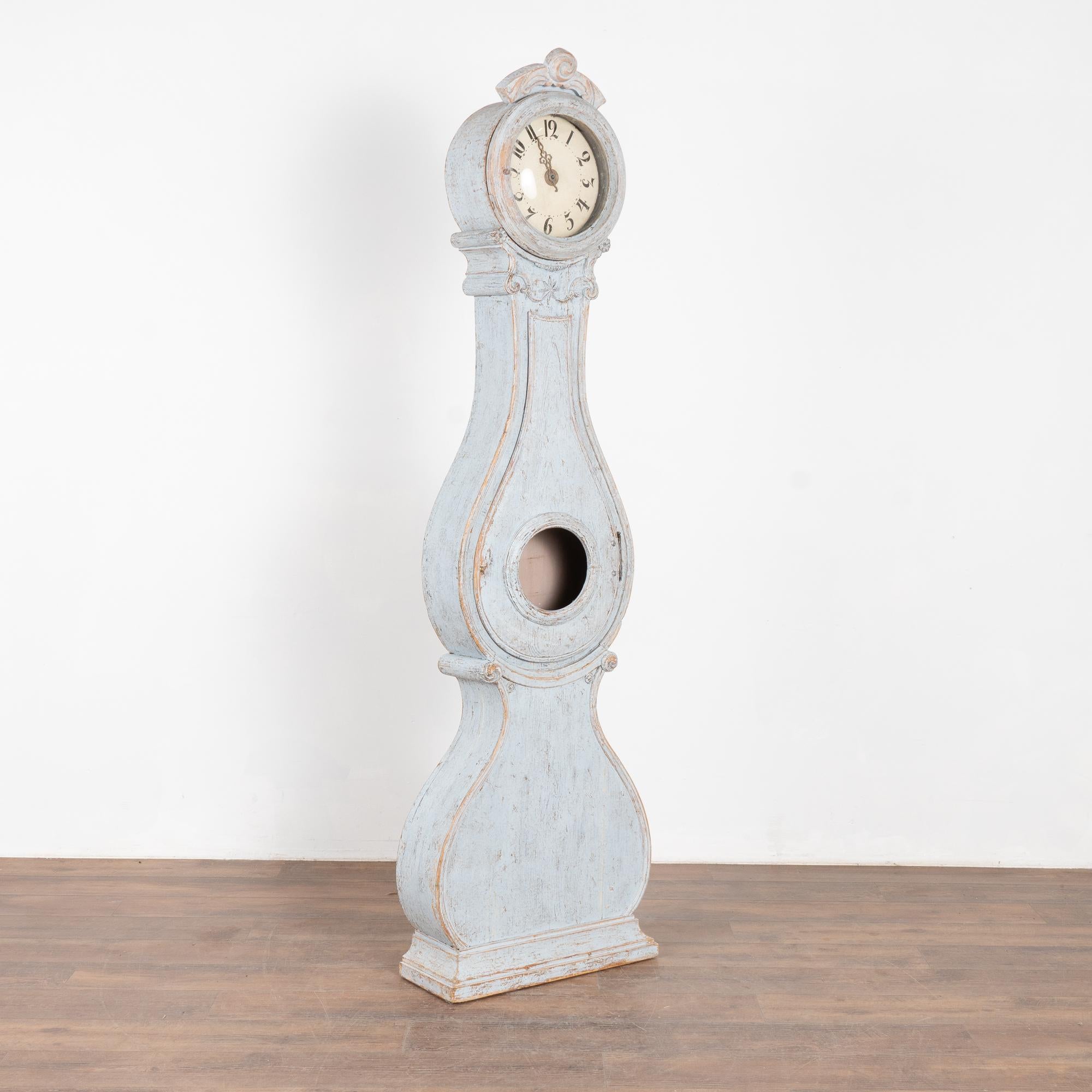 Swedish mora grandfather clocks are identified by their gentle curves and classic style as seen in this lovely longcase clock with carving accenting the face. Note the perfect balance between the curves of the belly over larger curve of the
