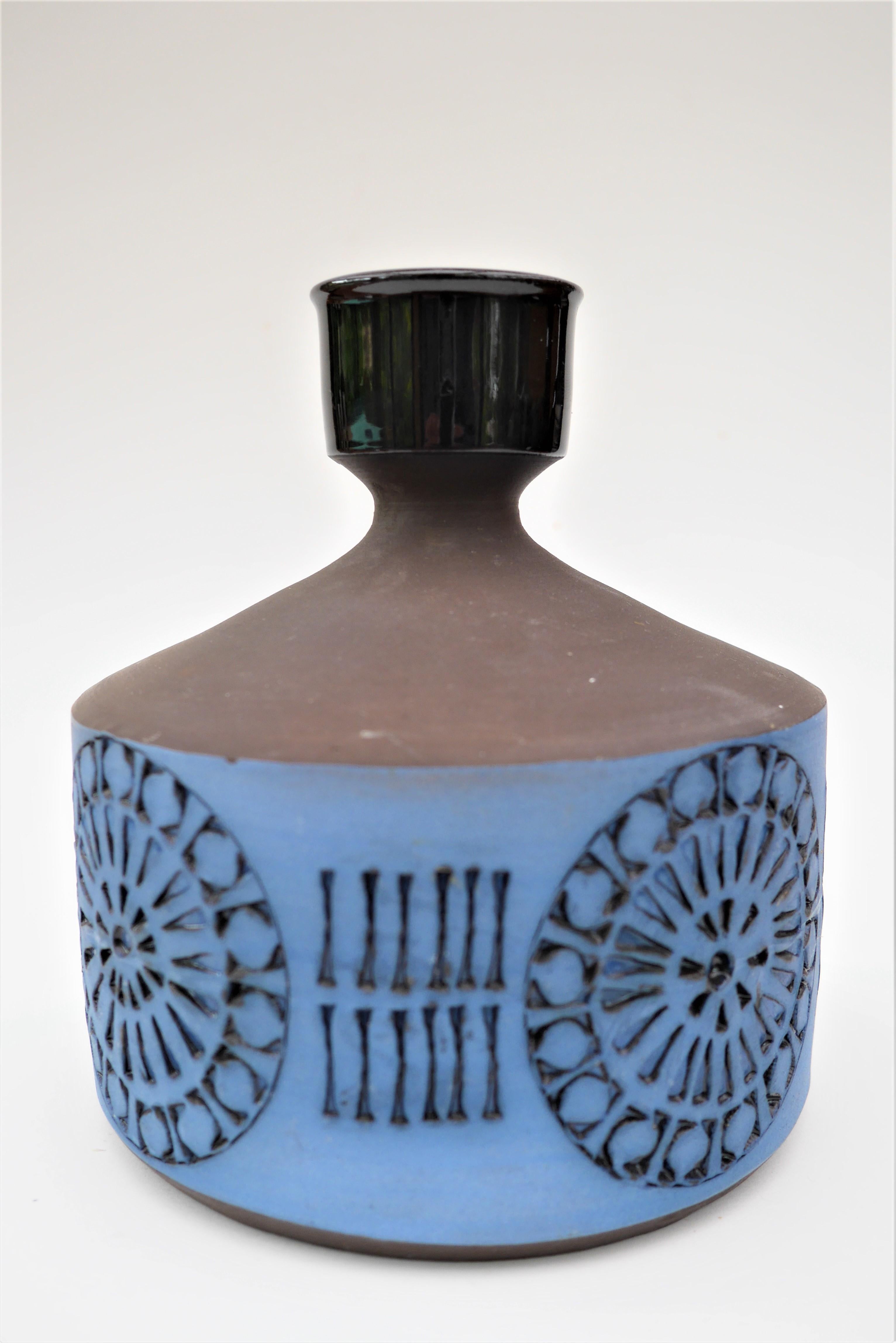 Glossy black glaze on the top and inside. Matt blue coloured glaze around the patterned lower body. Hand carved graphic pattern around the base of the vase. Stamped and signed under base. Manufactured by Alingsås Keramik in the small Swedish town of