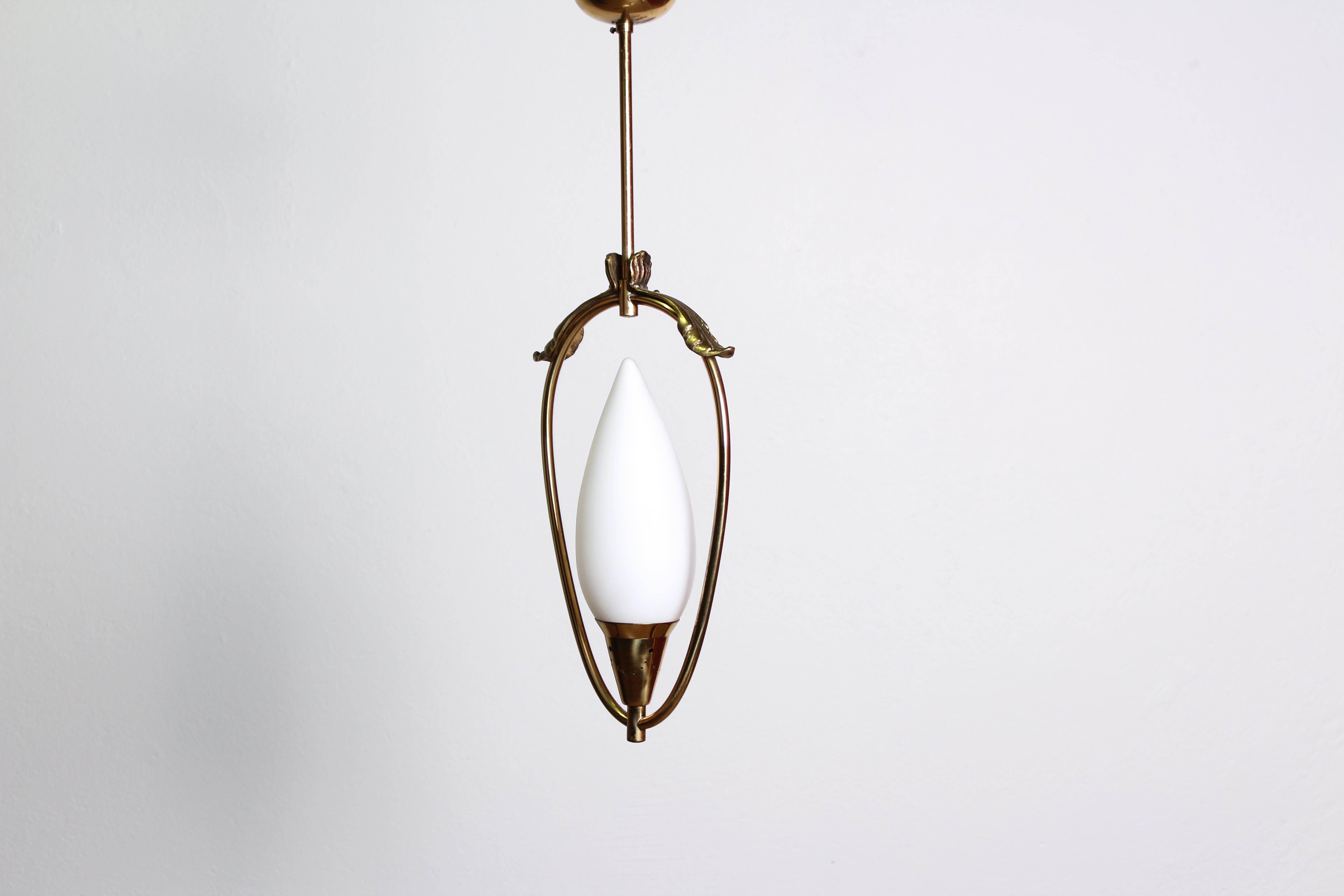 Beautiful Swedish ceiling lamp from the 1940s made out of brass and a opaline glass shade. This very decorative lamp is in very good vintage condition with minor signs of usage and patina. The electrics have been tested and is fully working.