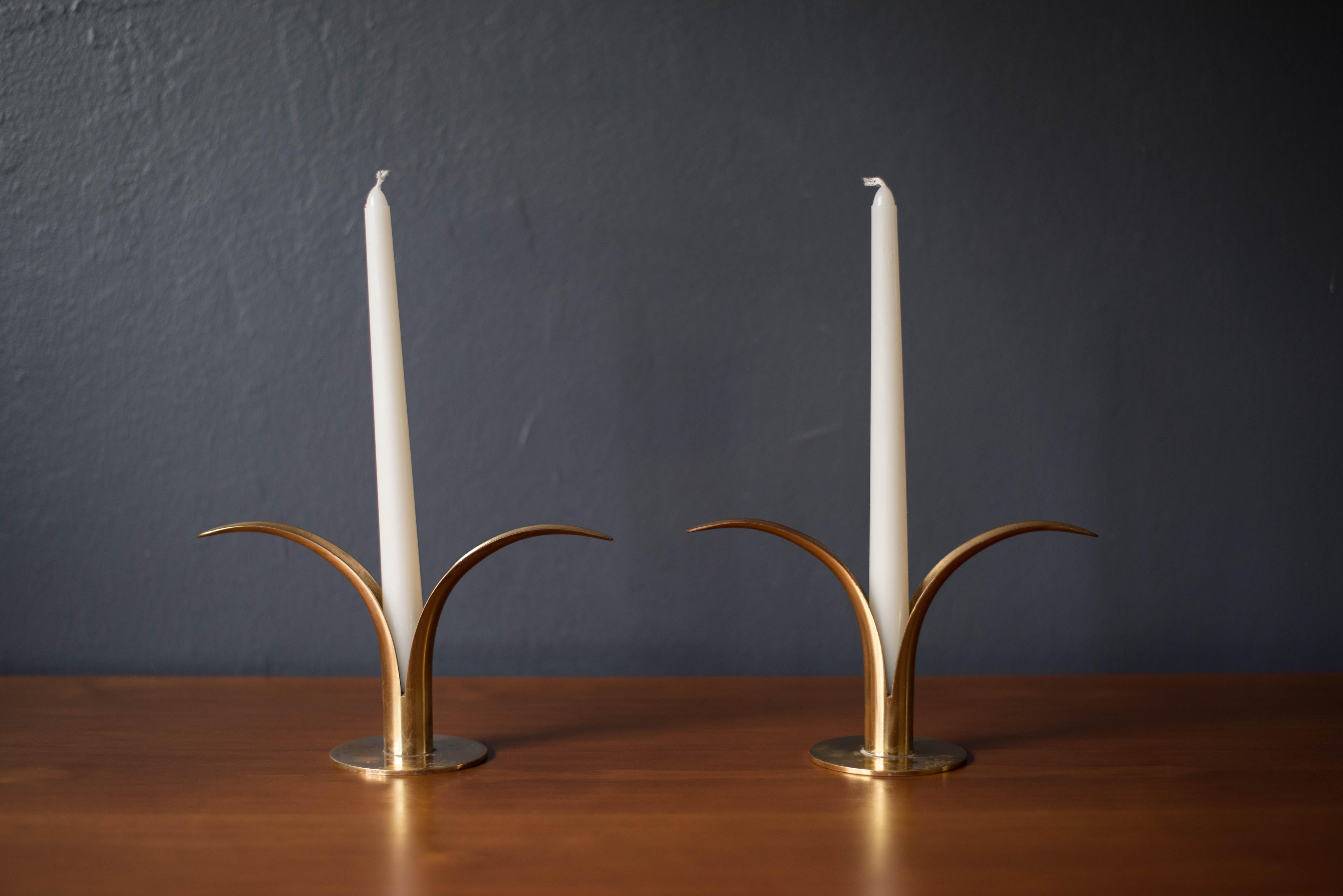 Mid-Century Modern pair of Liljan candleholders by sculptor Ivar Ålenius Björk for Ystad Metall of Sweden. Designed to fit taper candlesticks, this set features a sculptural 