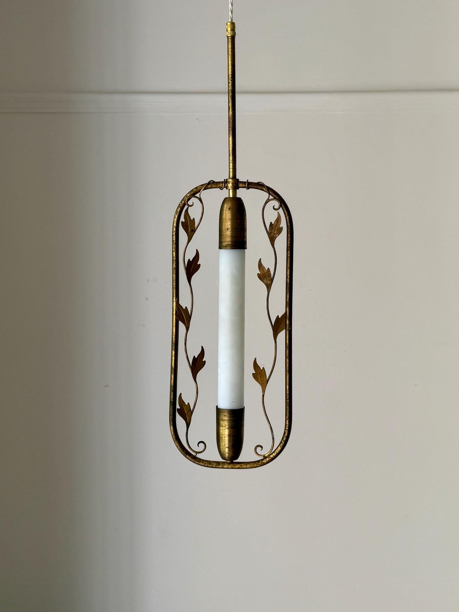 A simple brass pendant light with delicate twists of decoration in the form of brass leaves. First half twentieth century, in art deco style, Sweden.

The item is in fair vintage condition with lots of patina to the brass, which has been left
