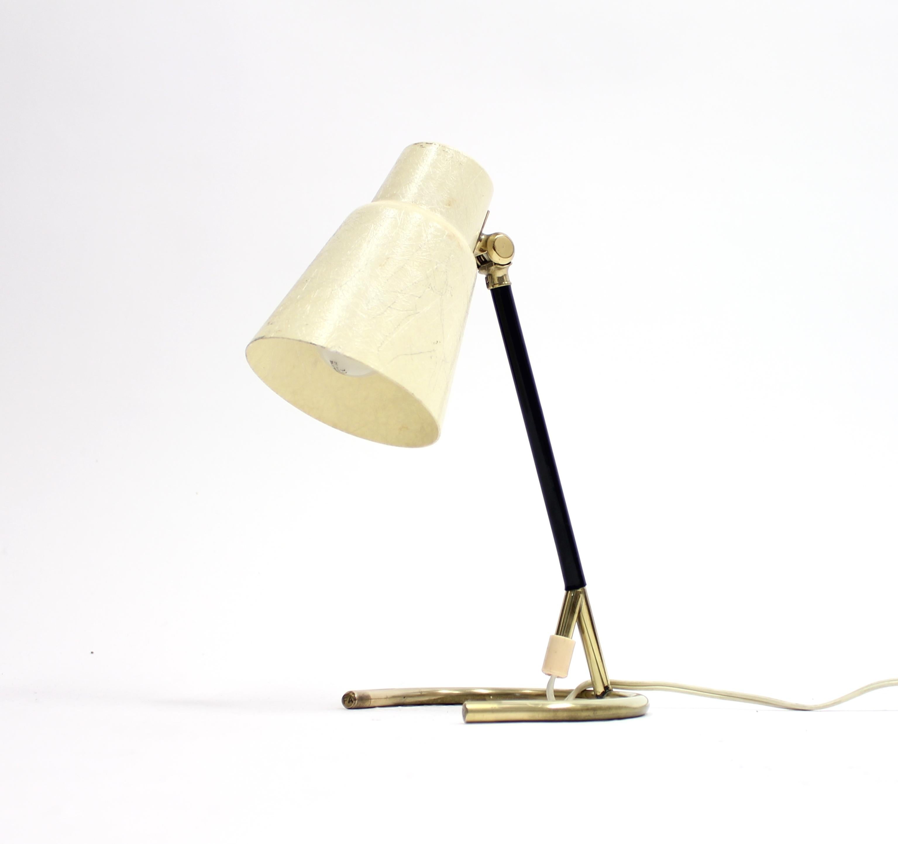 Brass table lamp with circular foot, off-white fibreglass shade. Most likely made in Sweden by Falkenbergs belysning. Marked 