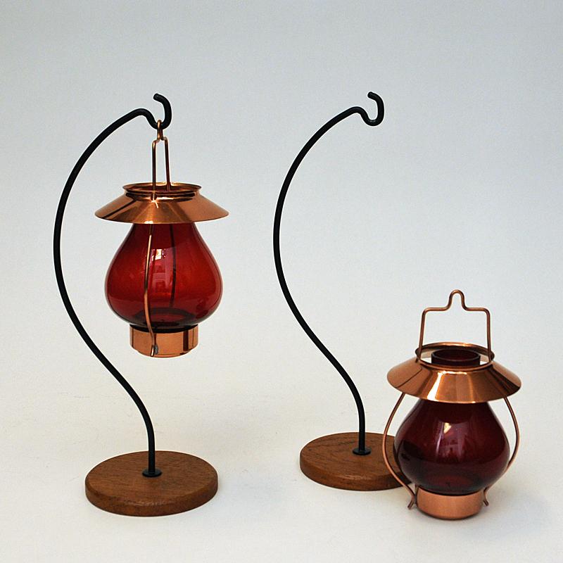 Polished Swedish bronze Candle holders with red glass by Gunnar Ander, Ystad Metall 1960s