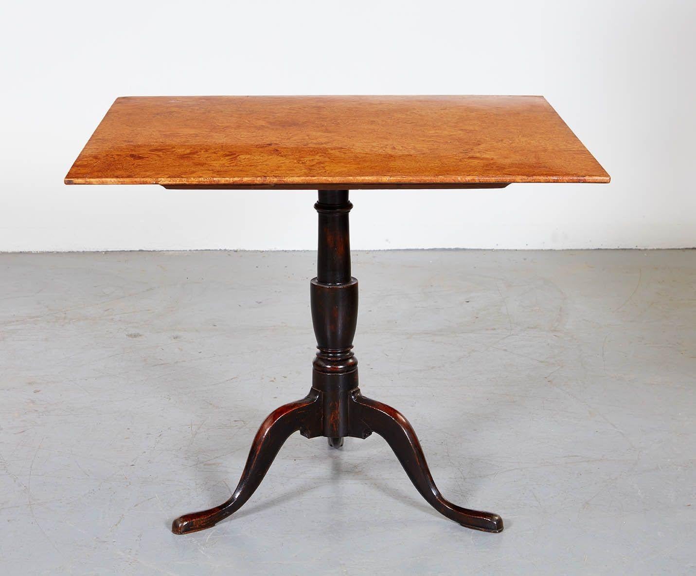 Fine Swedish early 19th century tilt top table, with the square top beautifully conceived in birch root burl veneer, on a pegged tilt hinge above an ebonized base with vasiform shaft over three slipper feet, the whole of striking design and