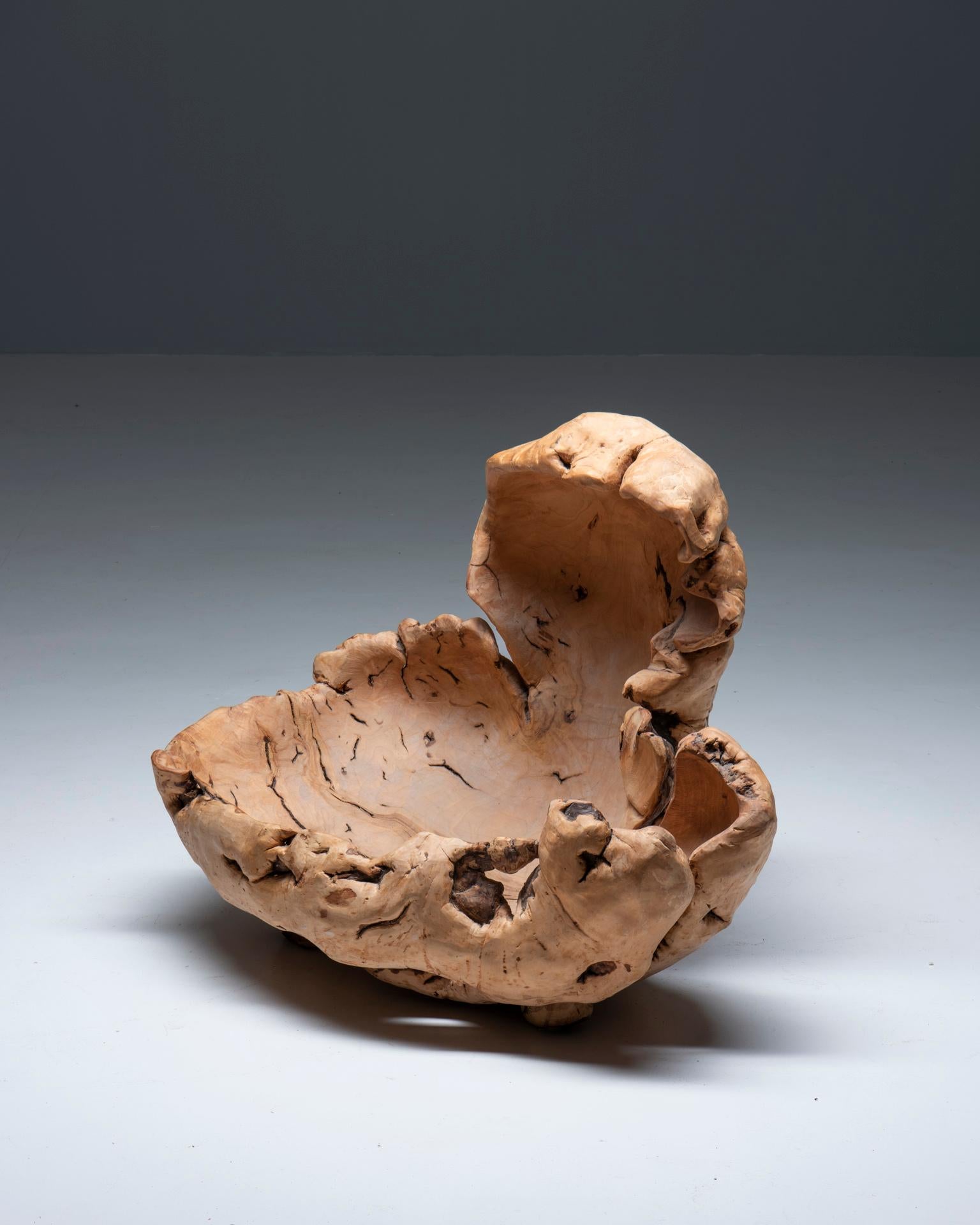 A large Swedish sculptural object made from burl wood. Hand carved form an ornamented inside, with Natural knotholes to add to the sculptural appeal of the work. This object is unsigned, but presumably made in Sweden in the 1960s.