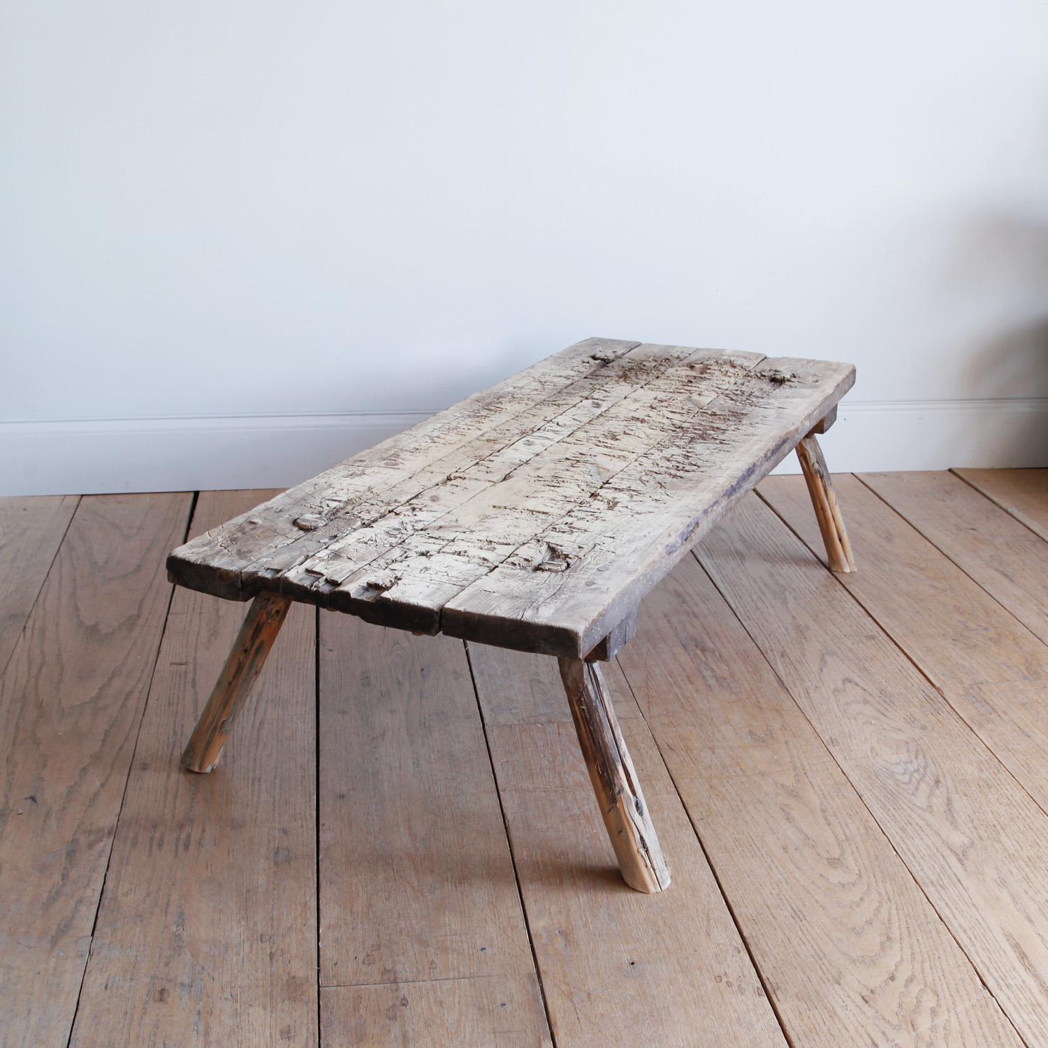We love the rough-hewn hand-built utilitarian furniture of this period, marked with generations of use and lending a rustic, wabi sabi elegance to any interior.

This long coffee table with its splayed legs and wooden peg joinery has an almost