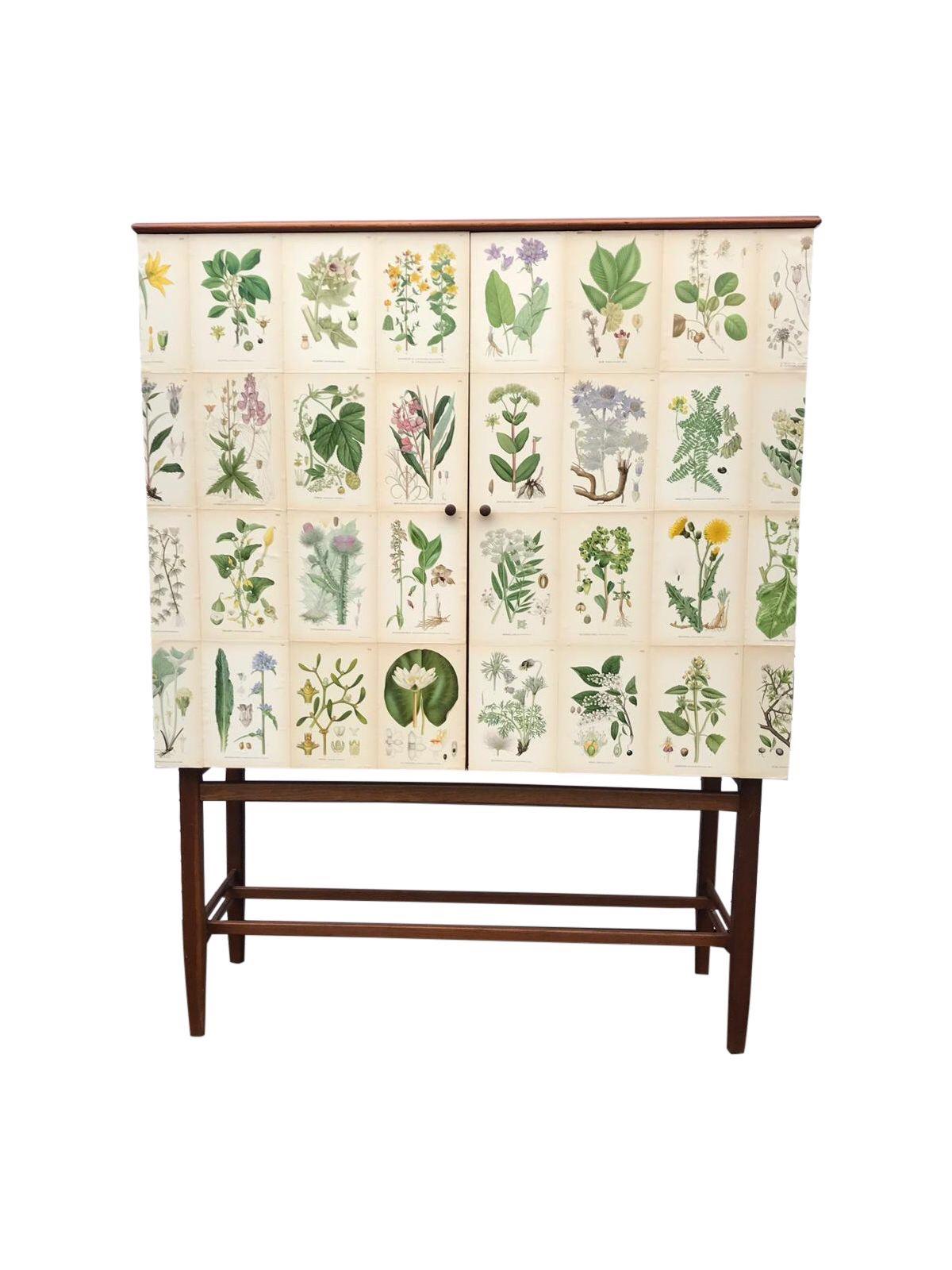 This fabulous Swedish vintage cabinet from the 1950s by famous maker FM Furniture, Linköping, 1950-1960. This piece has been restyled in our studio and covered in these amazing lithograph prints taken from C.A.M Lindman, Nordens Flora from 1926 then