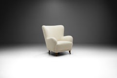 Swedish Cabinetmaker Wingback Chair with Stained Wood Legs, Sweden, circa 1940s