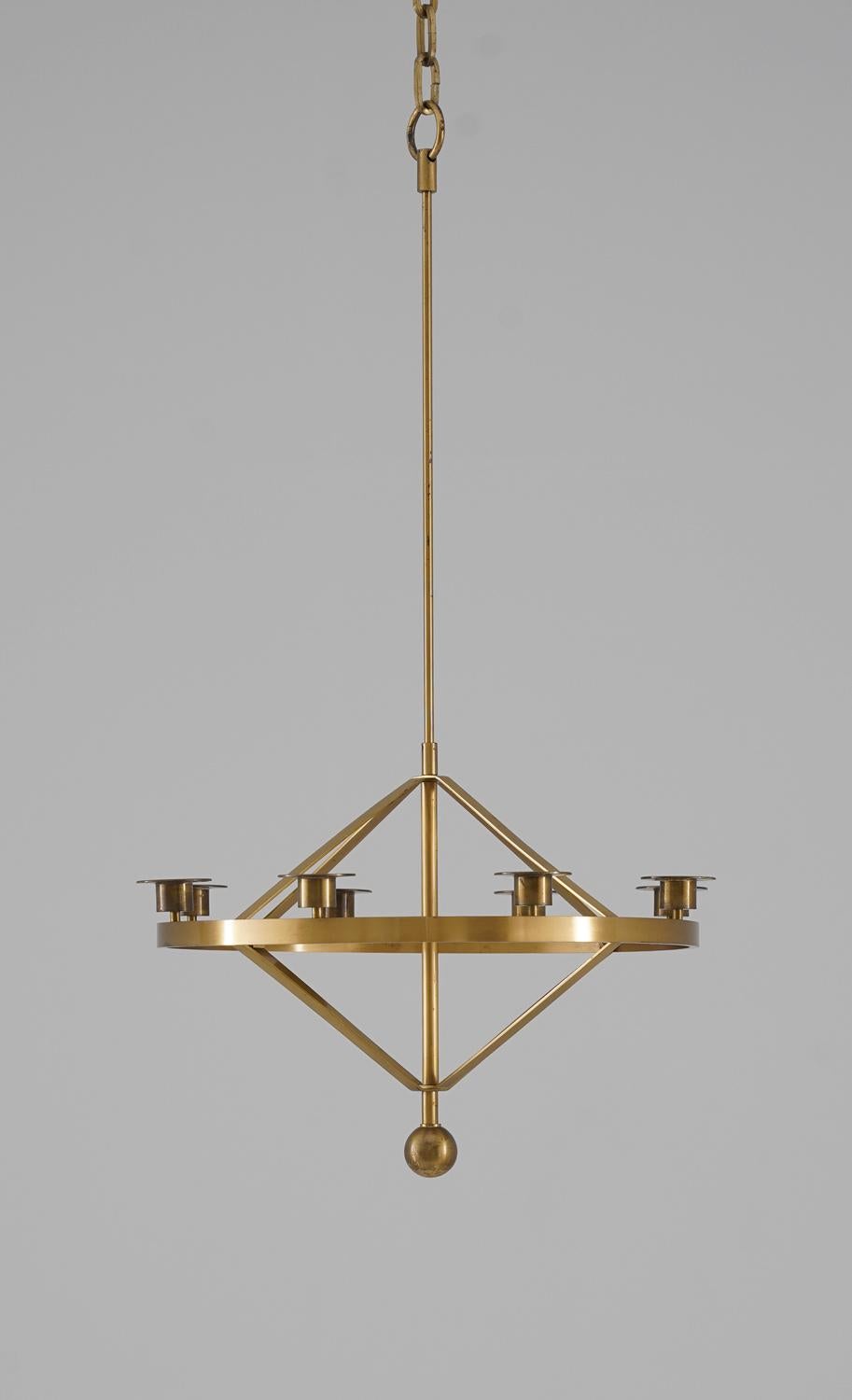 Beautiful candle chandelier with geometric shapes, manufactured in Sweden during the 1960s. The chandelier consists of a brass ring with eight candleholders for standard-sized candles. 

Condition: Very good vintage condition with signs of age.