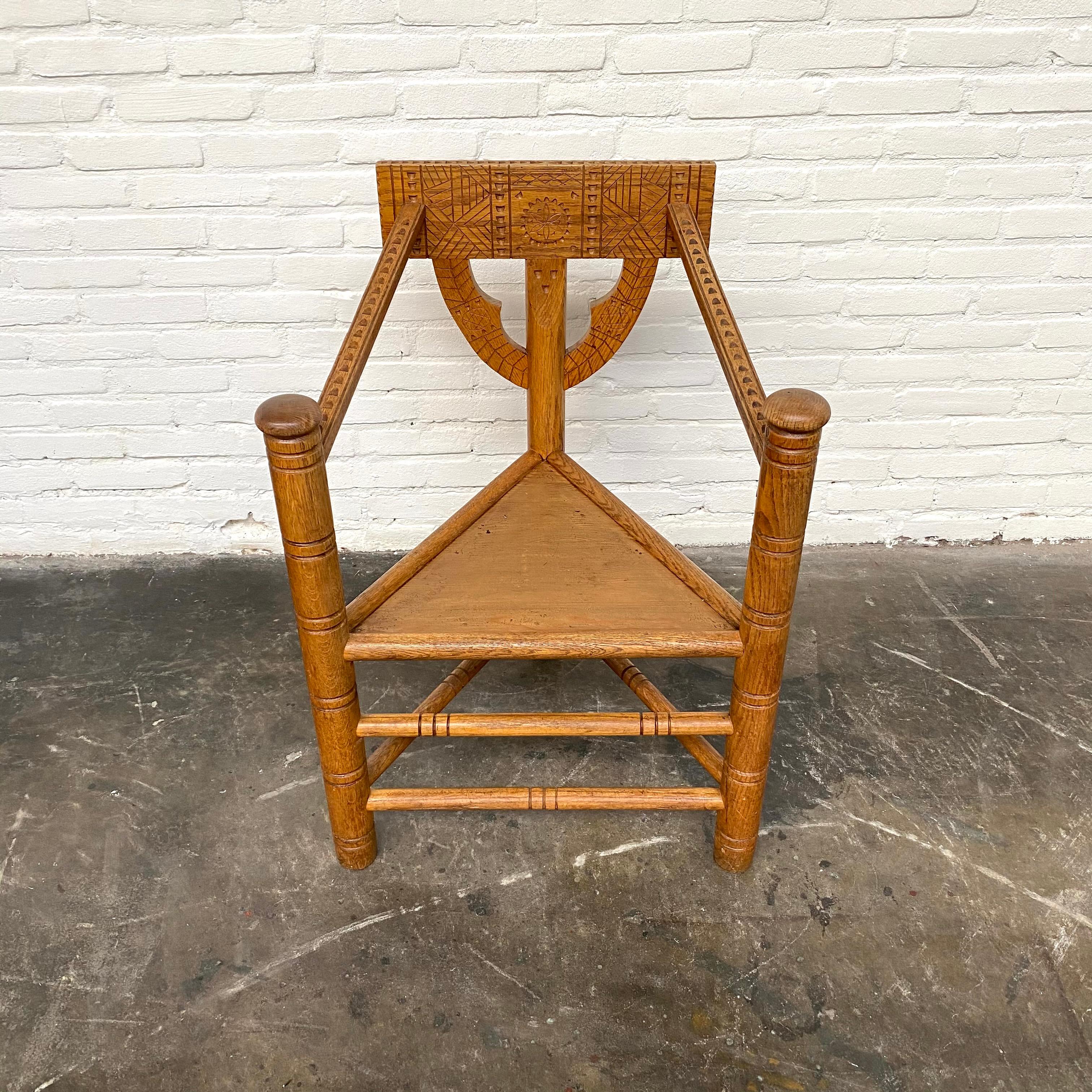 This Swedish monk chair is made of solid oak, handmade in the early 20th century. The chair is ornated with delicate carvings.