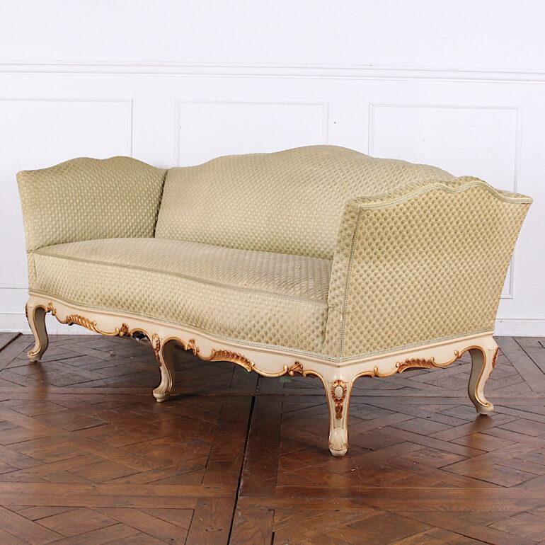 An elegant Swedish Louis XV style settee or sofa with ornately carved calloped apron and legs with a painted and gilt accented finish. Available with a matching armchair. 
    
  