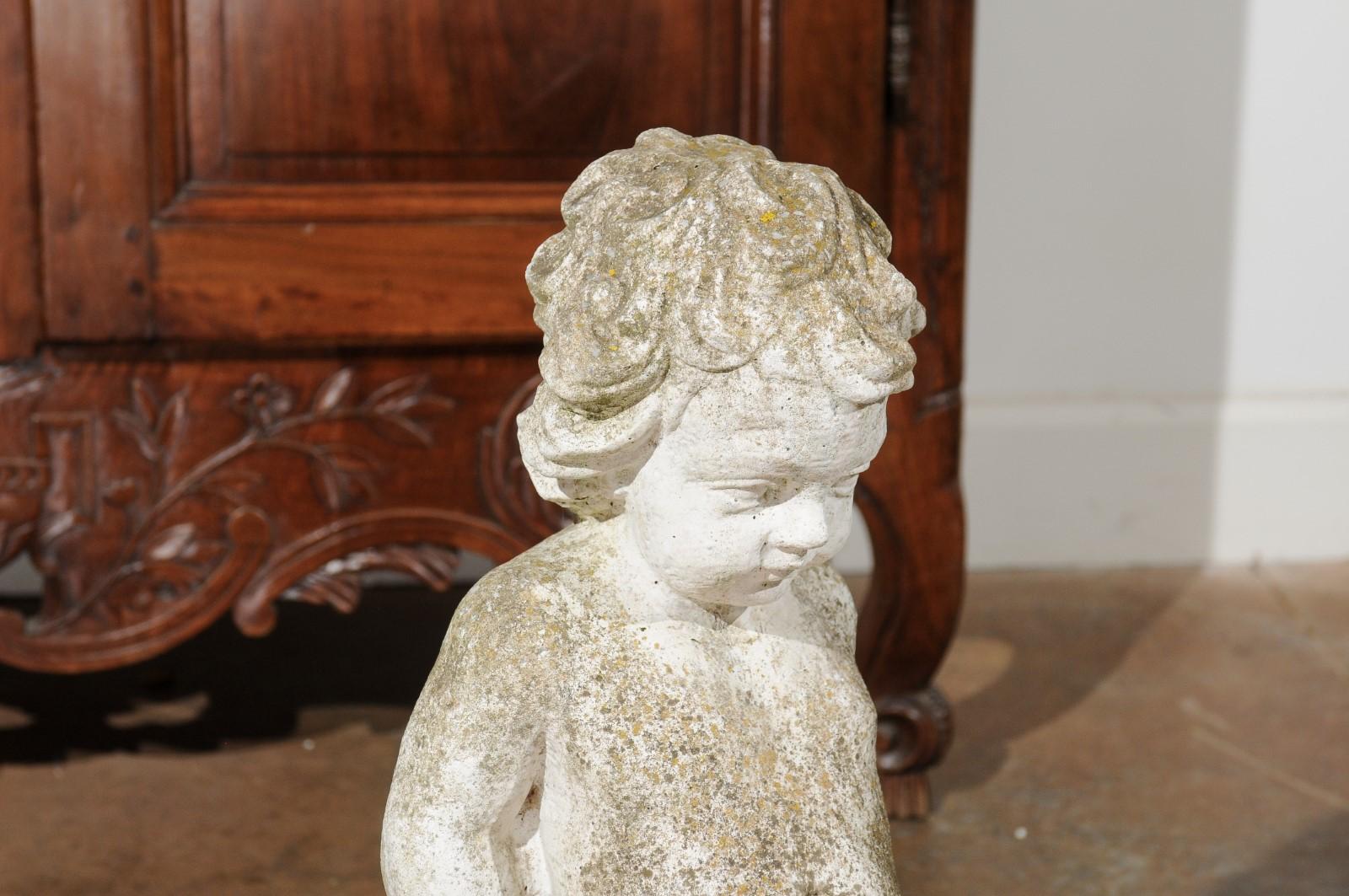 Swedish Carved Stone Garden Sculpture of a Putto Sitting on a Rock, 20th Century In Good Condition For Sale In Atlanta, GA