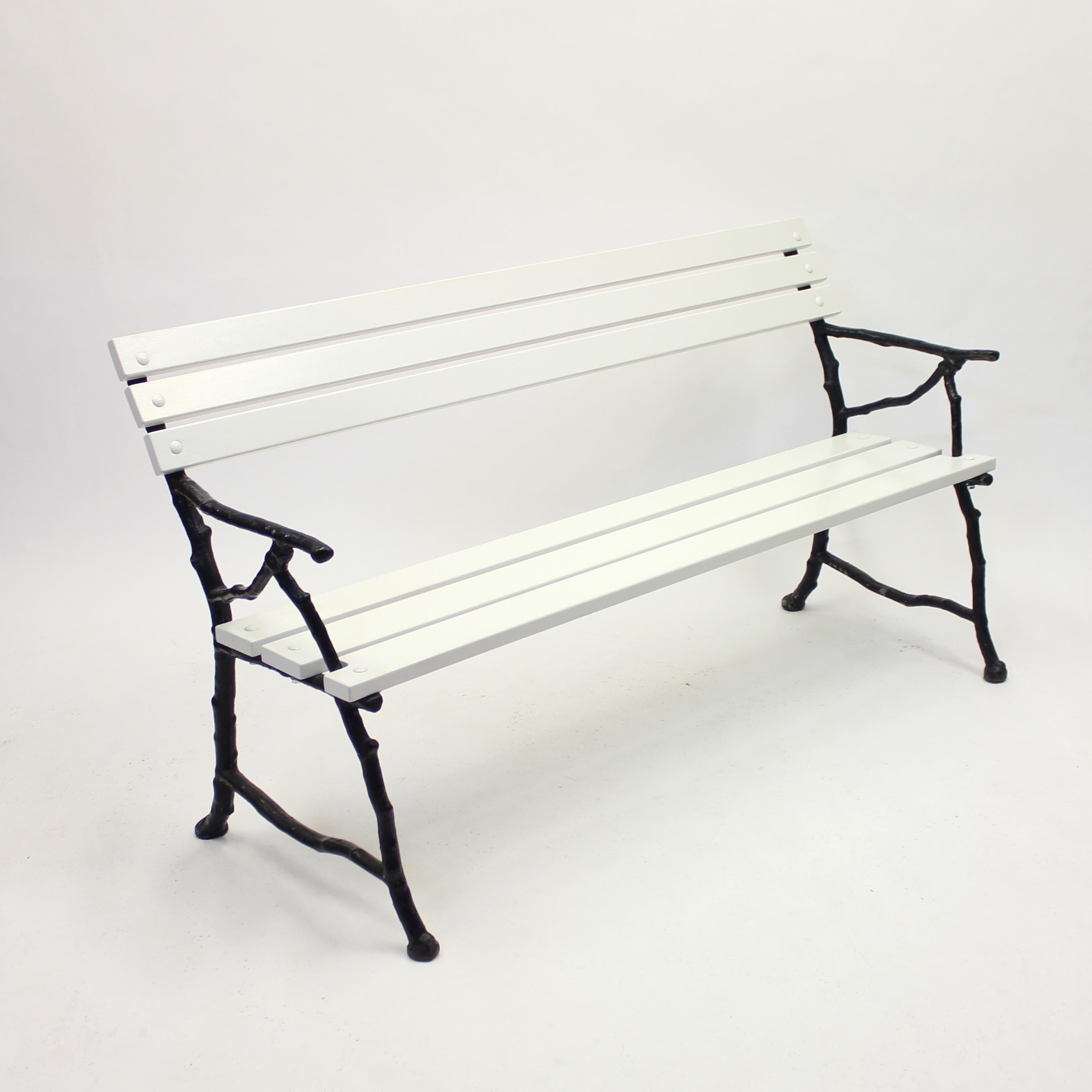 Swedish cast iron garden sofa with white painted wooden plank seat and back. The black cast iron frame, depicting tree branches, is from the early 20th century. The seat and back are totally restored with new wood and new screws to keep this piece