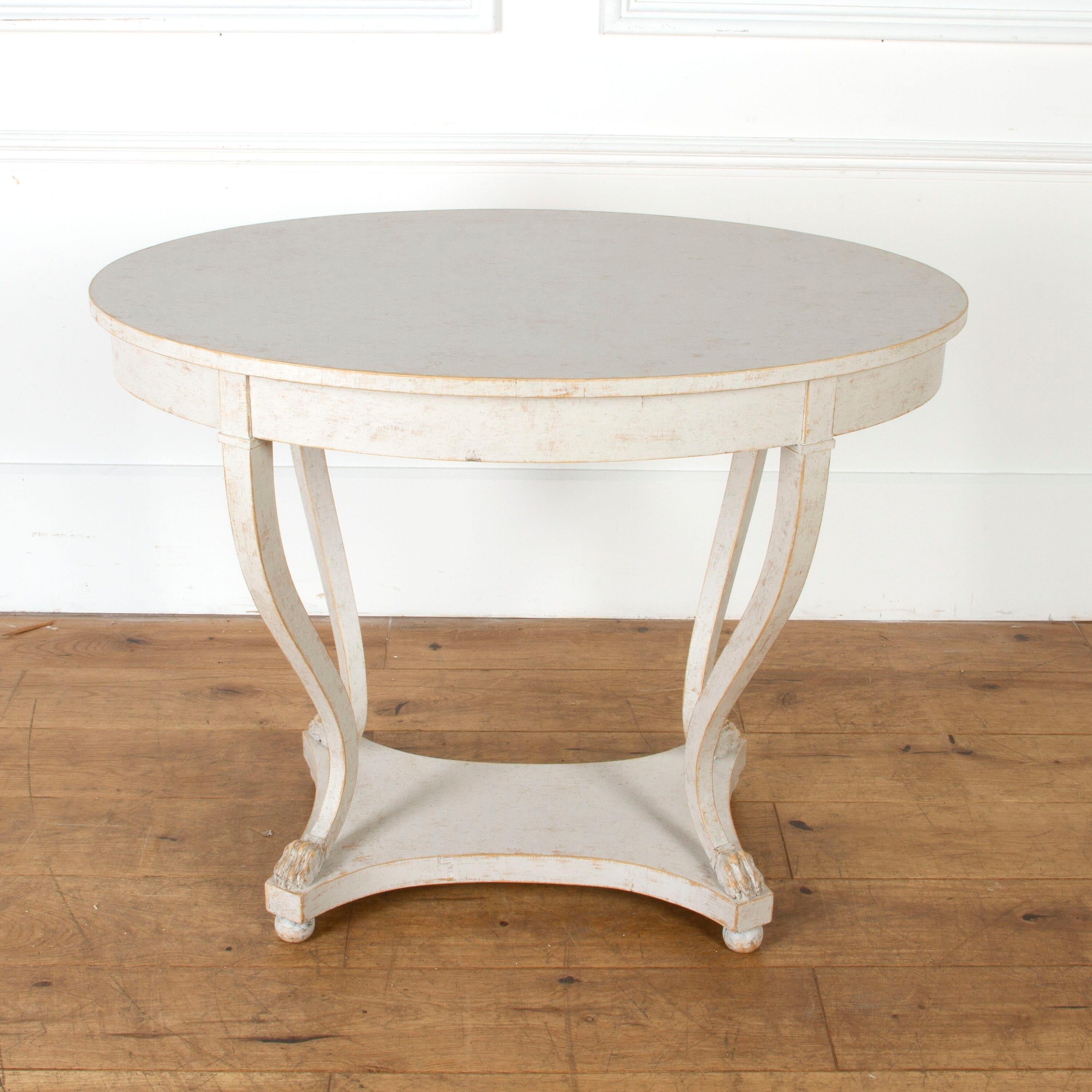 Lovely Empire style center table, circa 1860.

This wonderful table has a lovely form and proportions. 

The oval top is supported by four curved legs which all have fantastically carved, lions paw feet.

This table has been later painted with