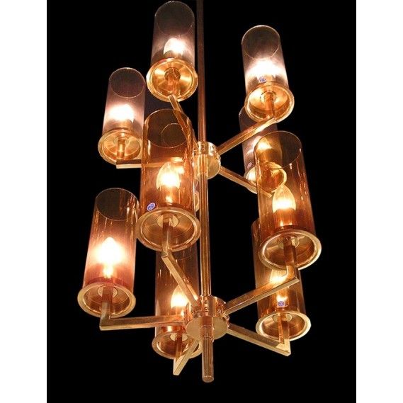 Tall Swedish 1960s chandelier by designer Hans-Agne Jakobsson. Ten light, brass and glass. Five lighter and five darker amber glass shades. Chandelier may be shown with shades alternating in color on each row or divided with lighter over darker, as