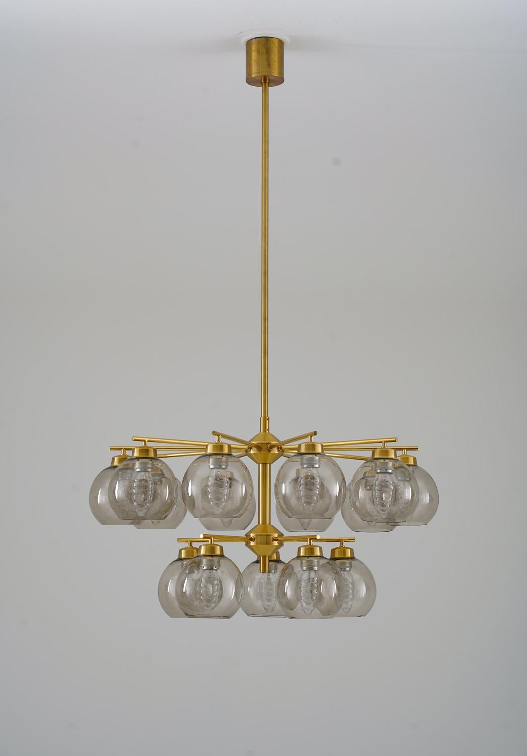 Mid-Century Modern chandeliers by Holger Johansson for Westal, Sweden.
The chandeliers consist of 15 round brass poles divided into two levels, each holding a smoke-colored glass shade.
The rods can be adjusted to your desired