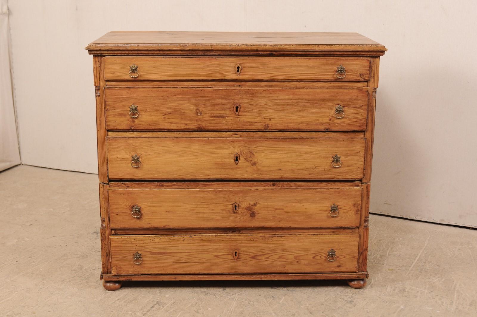 A Swedish chest of five drawers from the mid-19th century. This antique chest-on-chest from Sweden consists of two casement pieces, one stacking atop the other, which combined house a total of five drawers, with the top drawer being more shallow