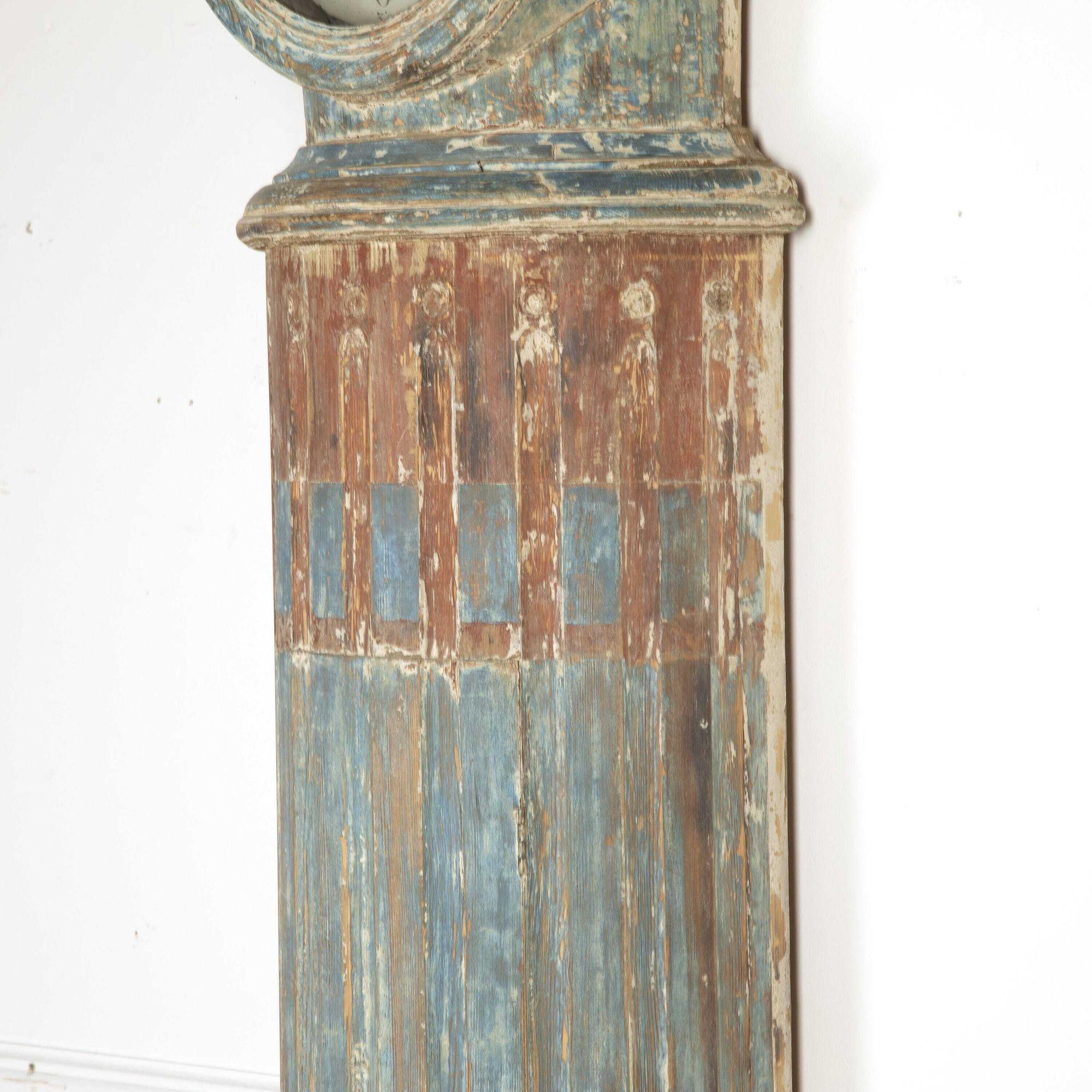 Swedish early 19th Century column clock with original painted decoration.
This clock has a lovely elegant shape, with unusual scrolled decoration to the neck. It has been dry-scraped to its original paint that is rich in patina and graining. 
A
