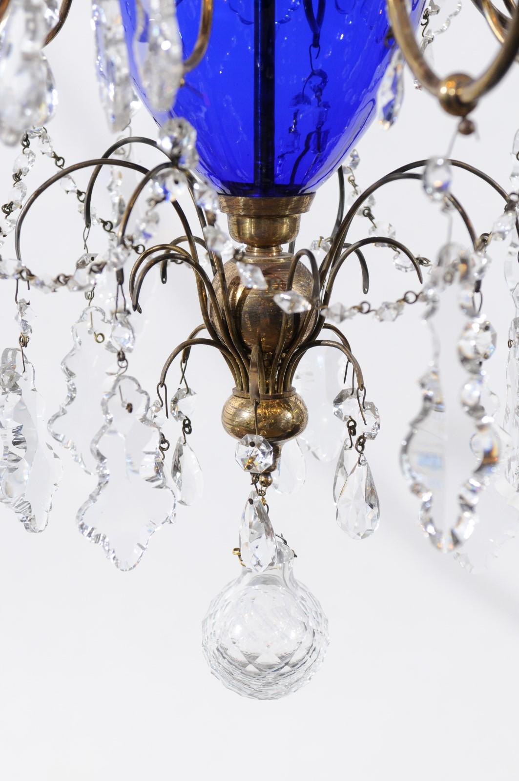 A Swedish chandelier with brass frame, cobalt blue blown glass, 12-light and crystal pendants. The chandelier recently wired for the U.S.A. electricity.

         