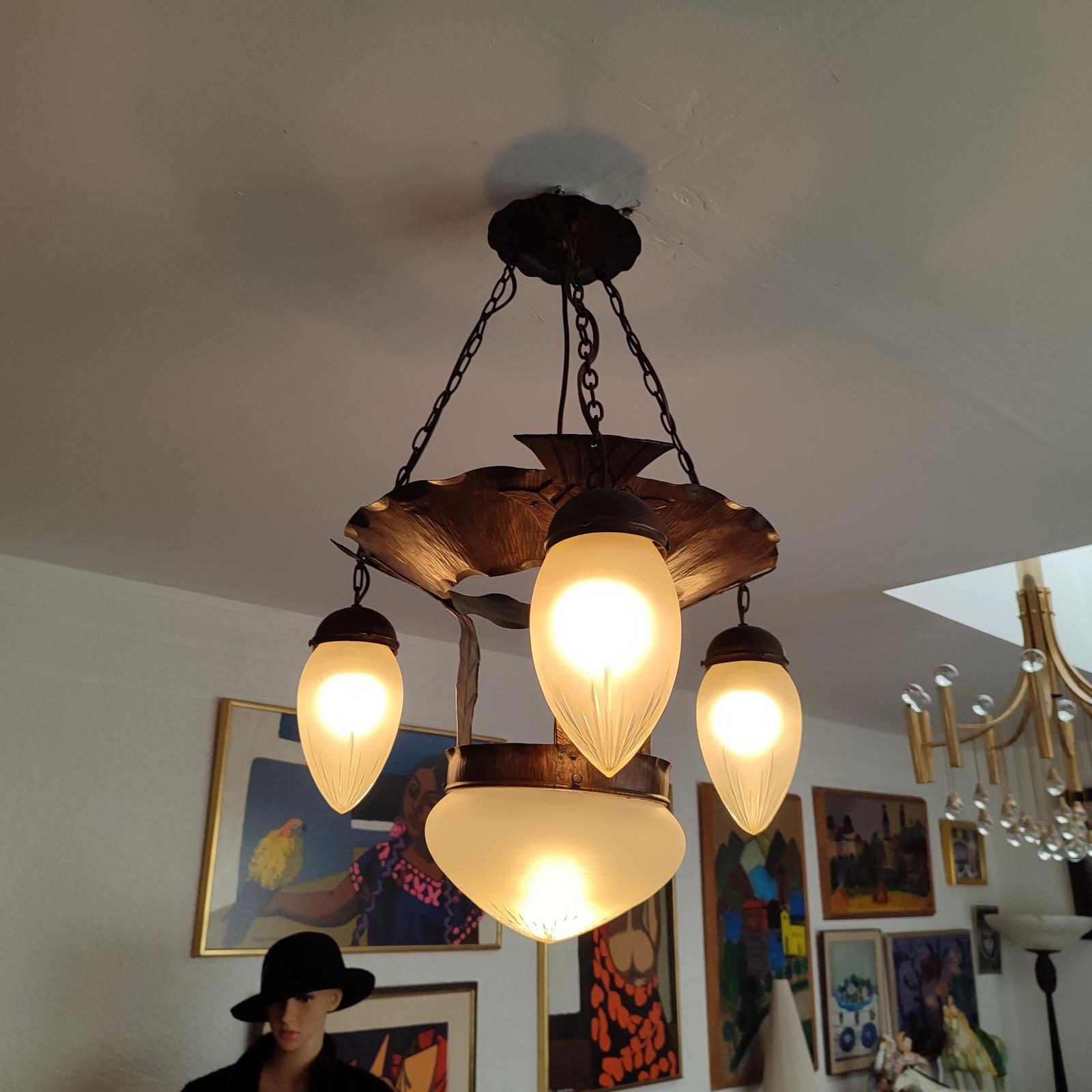 Fine Swedish Jugendstil suspension light from the 1910-1920s. The body is made of copper, entirely hammered. There are three lights embedded around the rim and a central one with a cut satin glass diffuser. Four original ceramic E27 sockets,