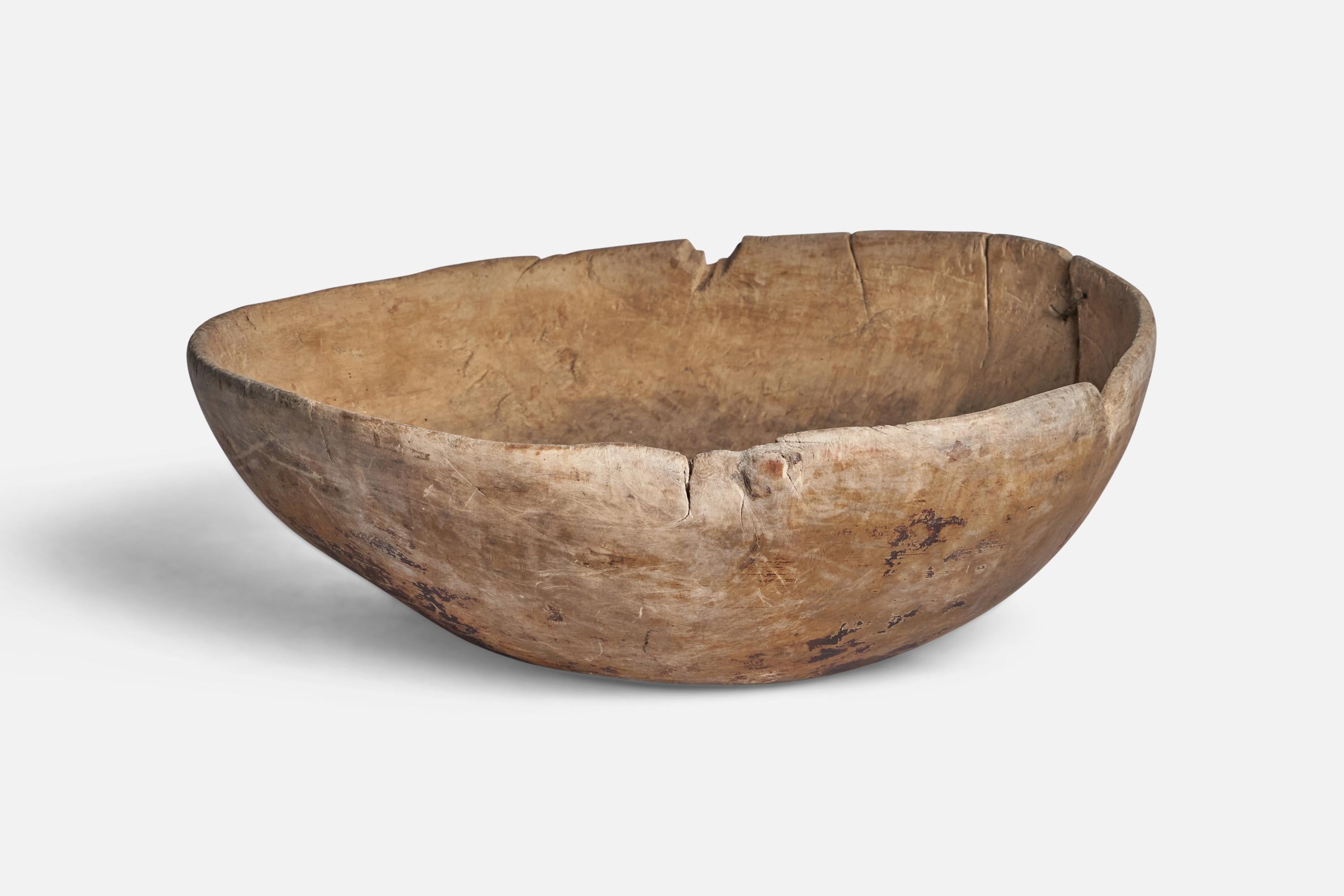 A wood bowl with metal repair produced in Sweden, 19th century.