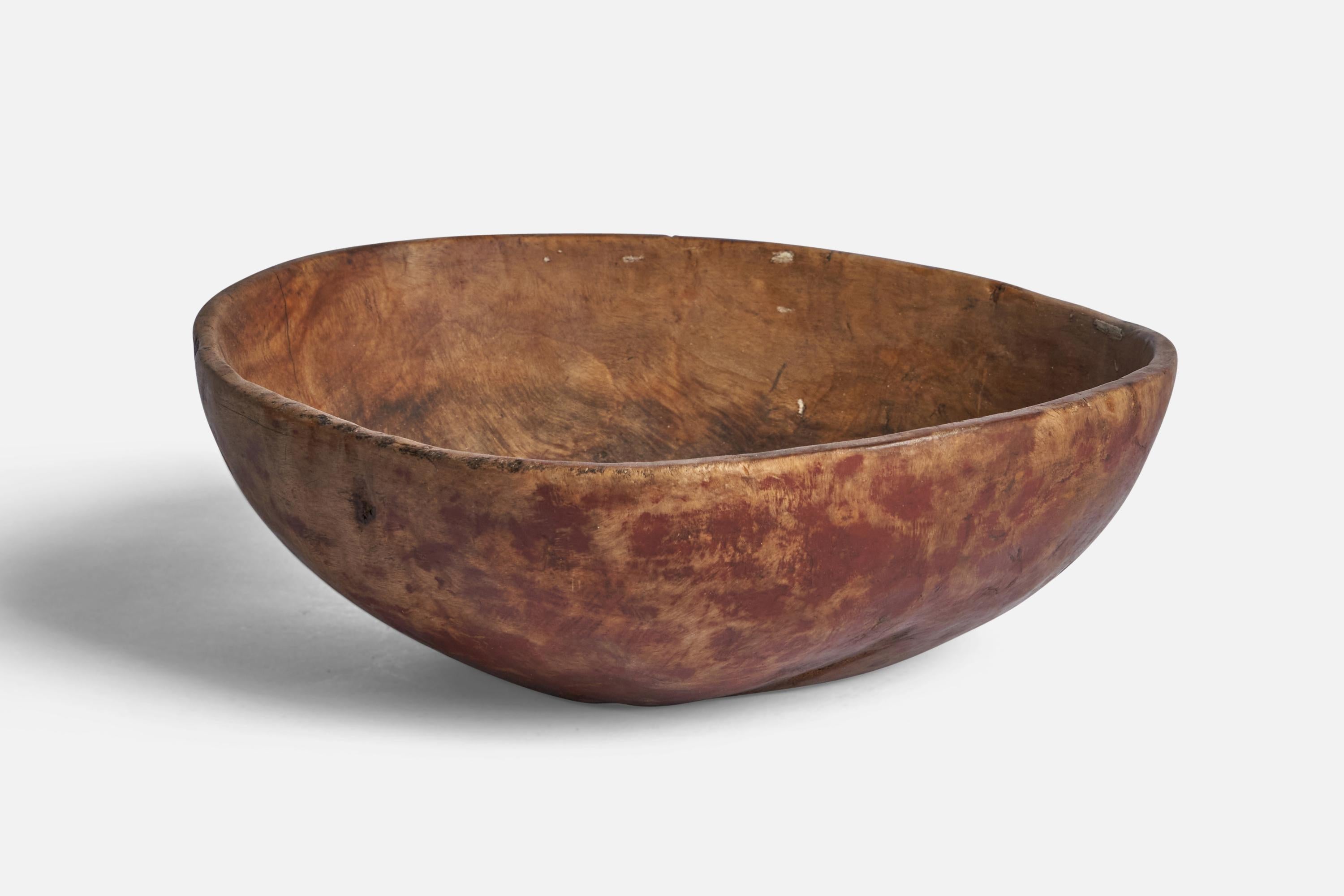 A red-painted wood bowl designed and produced in Sweden, 19th century.