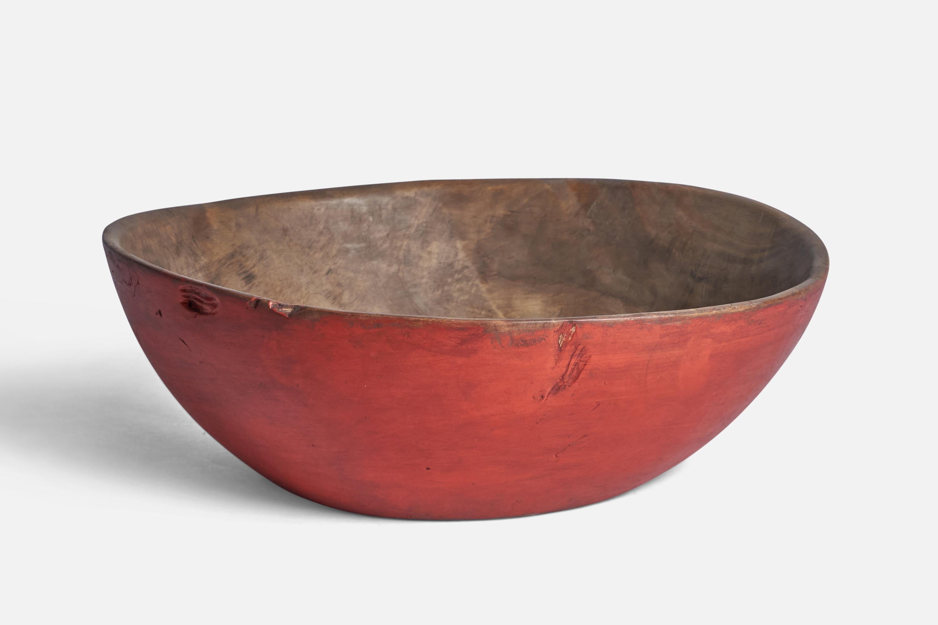 A red-painted wood bowl produced in Sweden, 19th Century.

