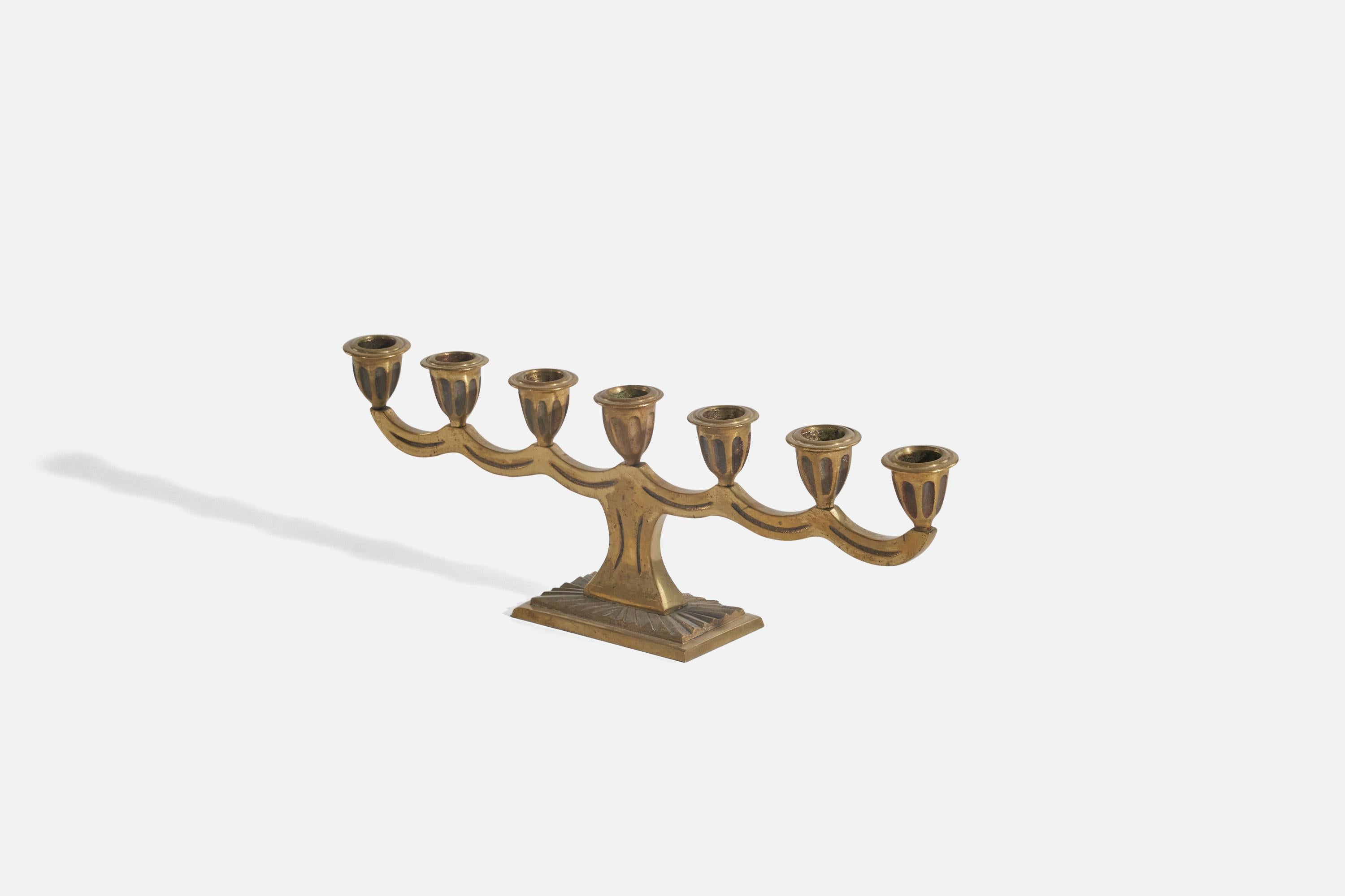 A brass, 7-candle candelabra designed and produced in Sweden, circa 1940s. With foundry stamp N.M.
  