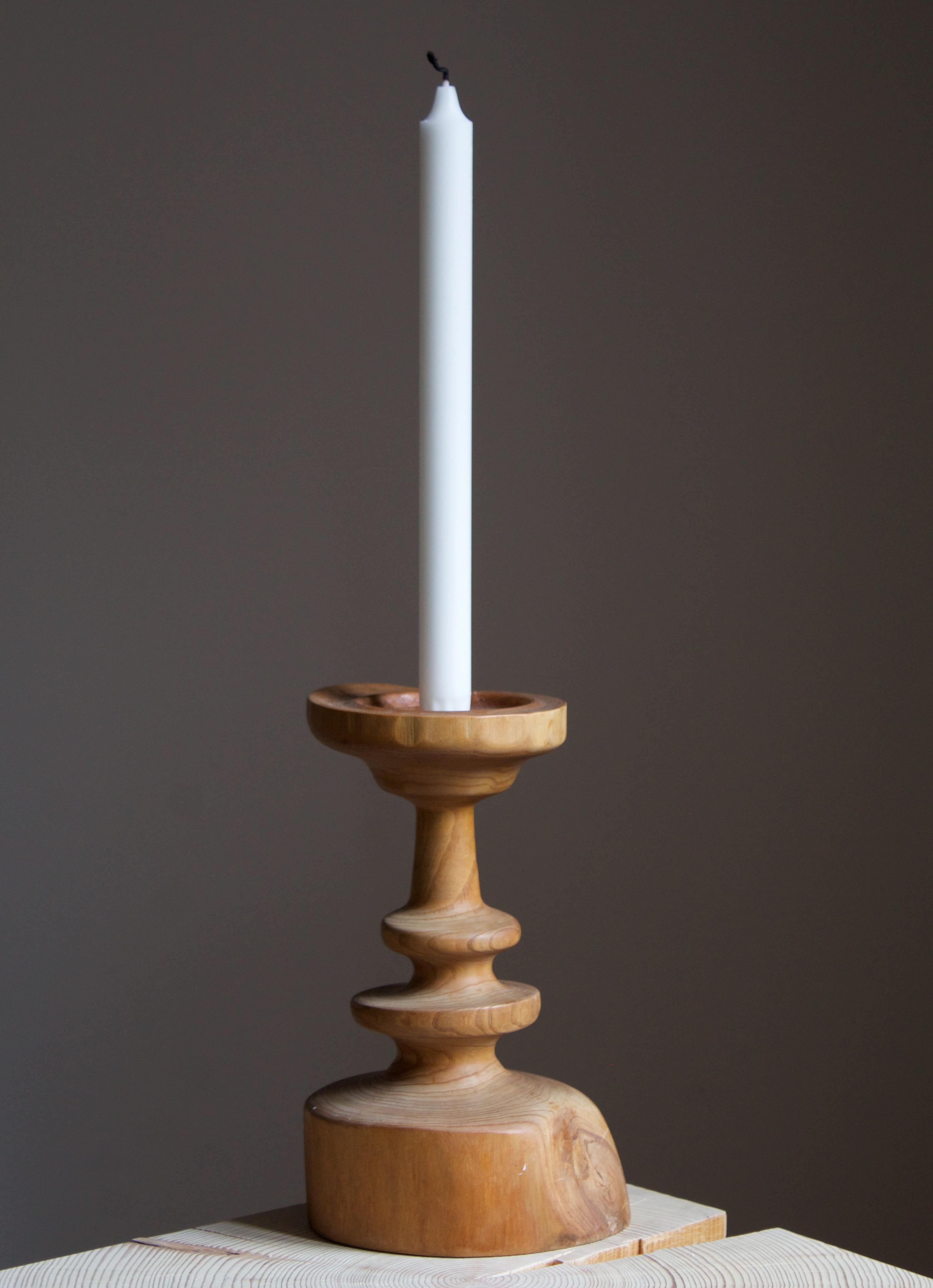A Swedish candlestick / candleholder. In carved solid pine. Brass nozzle.