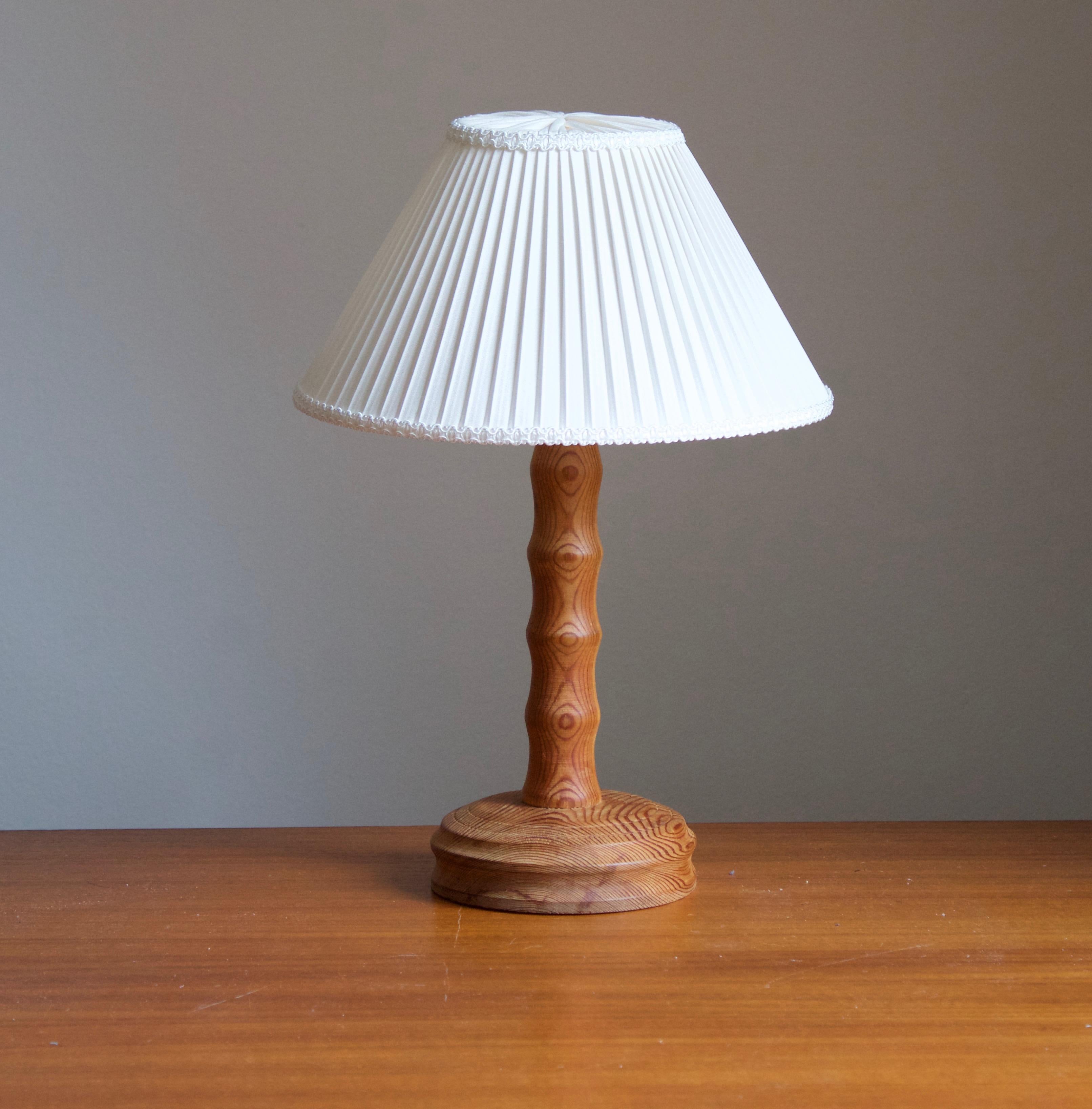 A table lamp designed and produced in Sweden, 1970s. In solid pine. 

Stated dimensions exlude lampshade, height includes socket. Upon request lampshade of model illustrated can be included in purchase.