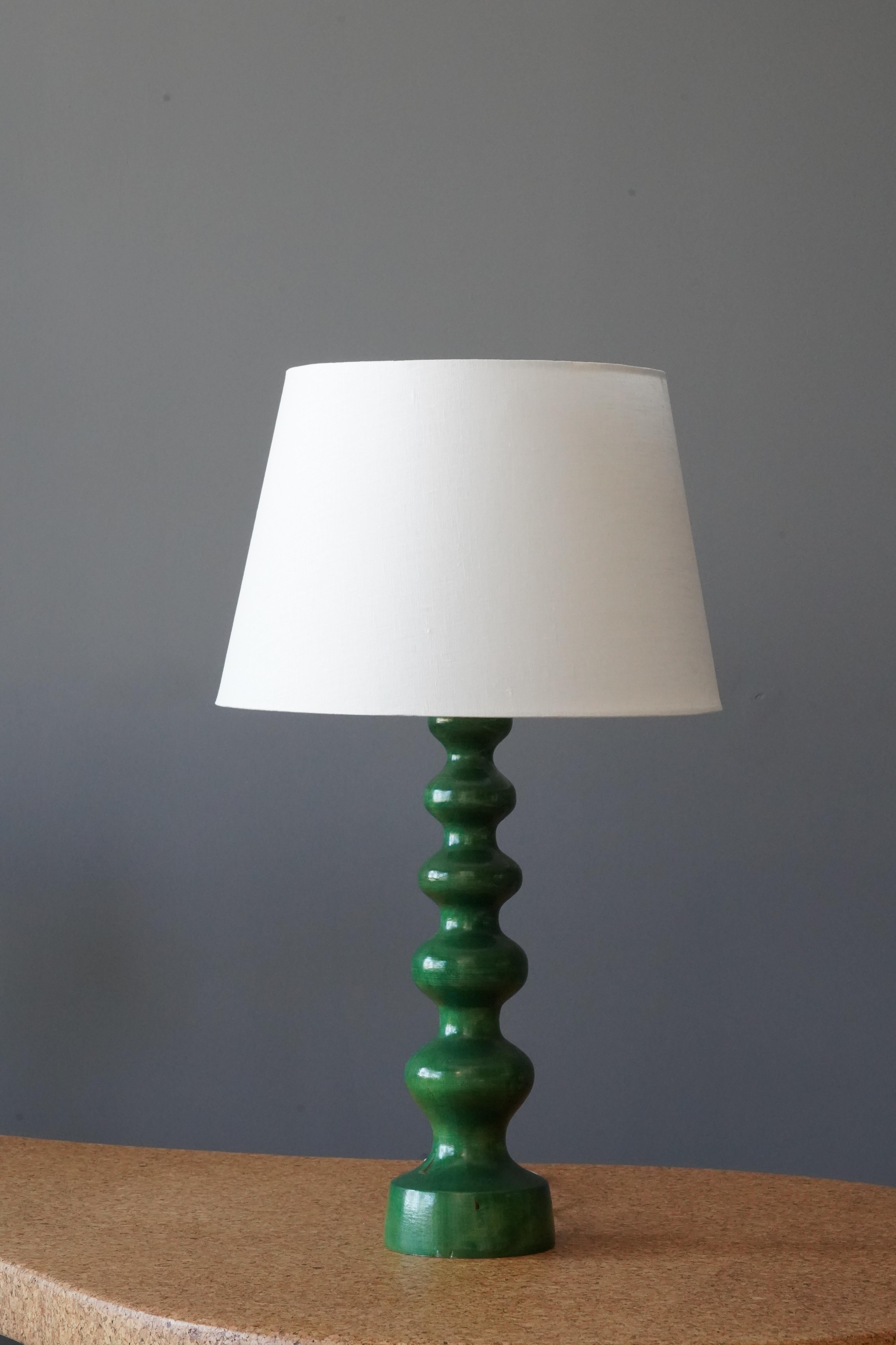 A table lamp designed and produced in Sweden in, c. 1960s. Green paint.

Stated dimensions exlude lampshade, height includes socket. Sold without lampshade.