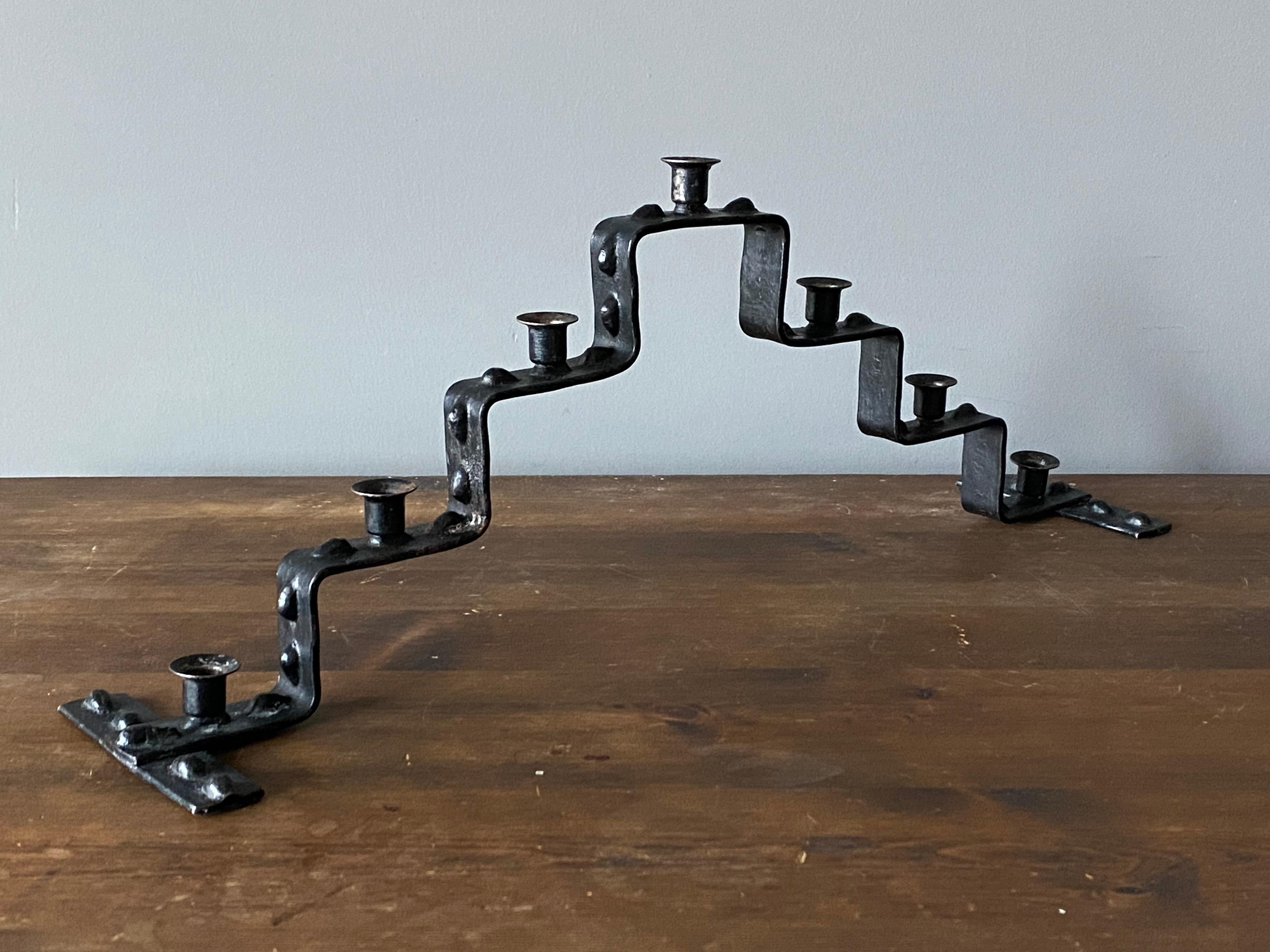 A pair of 7-candle candelabras. Produced in Sweden, circa 1950s. In welded and black-painted iron. Fits small candles.

 