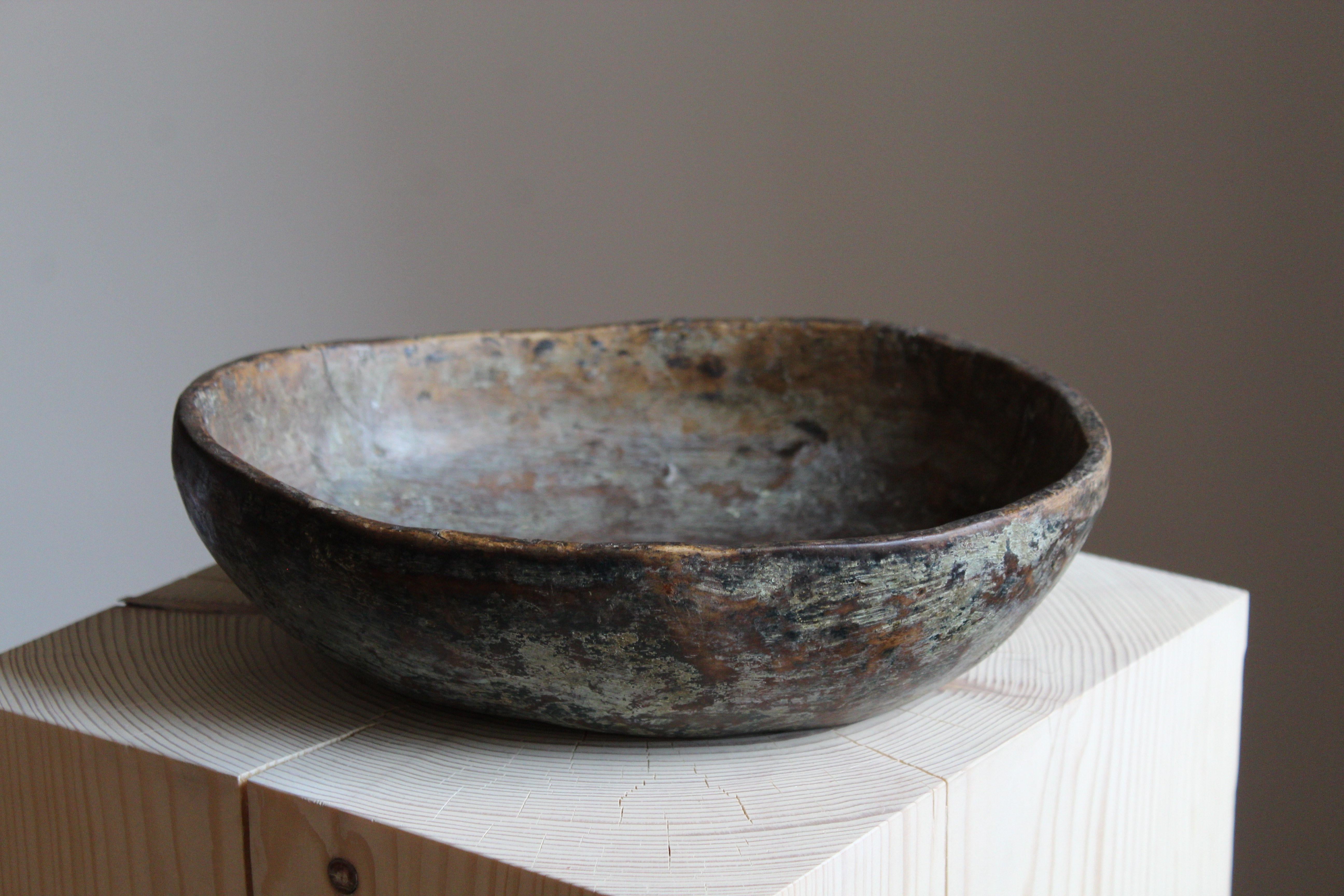 An antique Swedish folk craft bowl, 19th century. Signed HLHS. With exceptional antique patina.

 