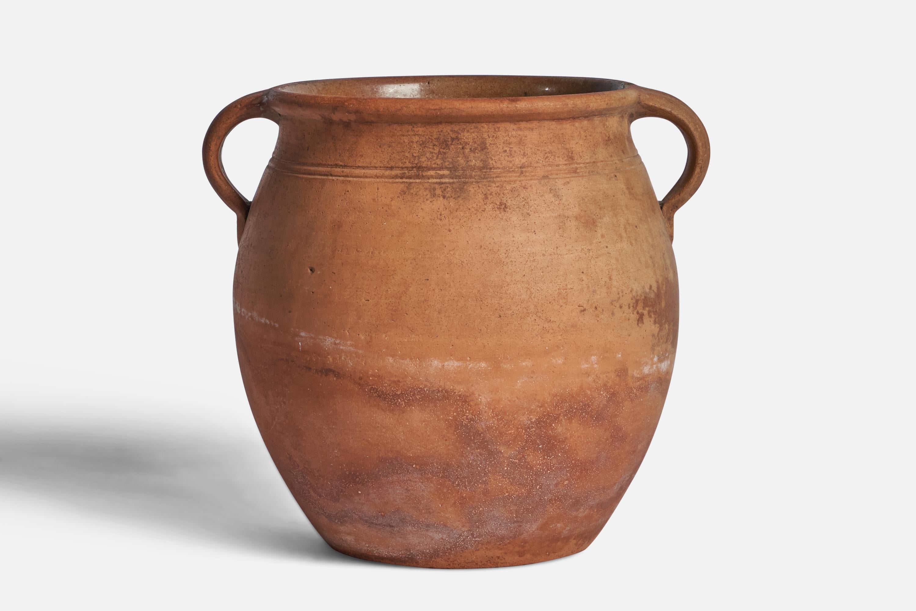 An unglazed terra-cotta earthenware vase designed and produced in Sweden, c. 1900.