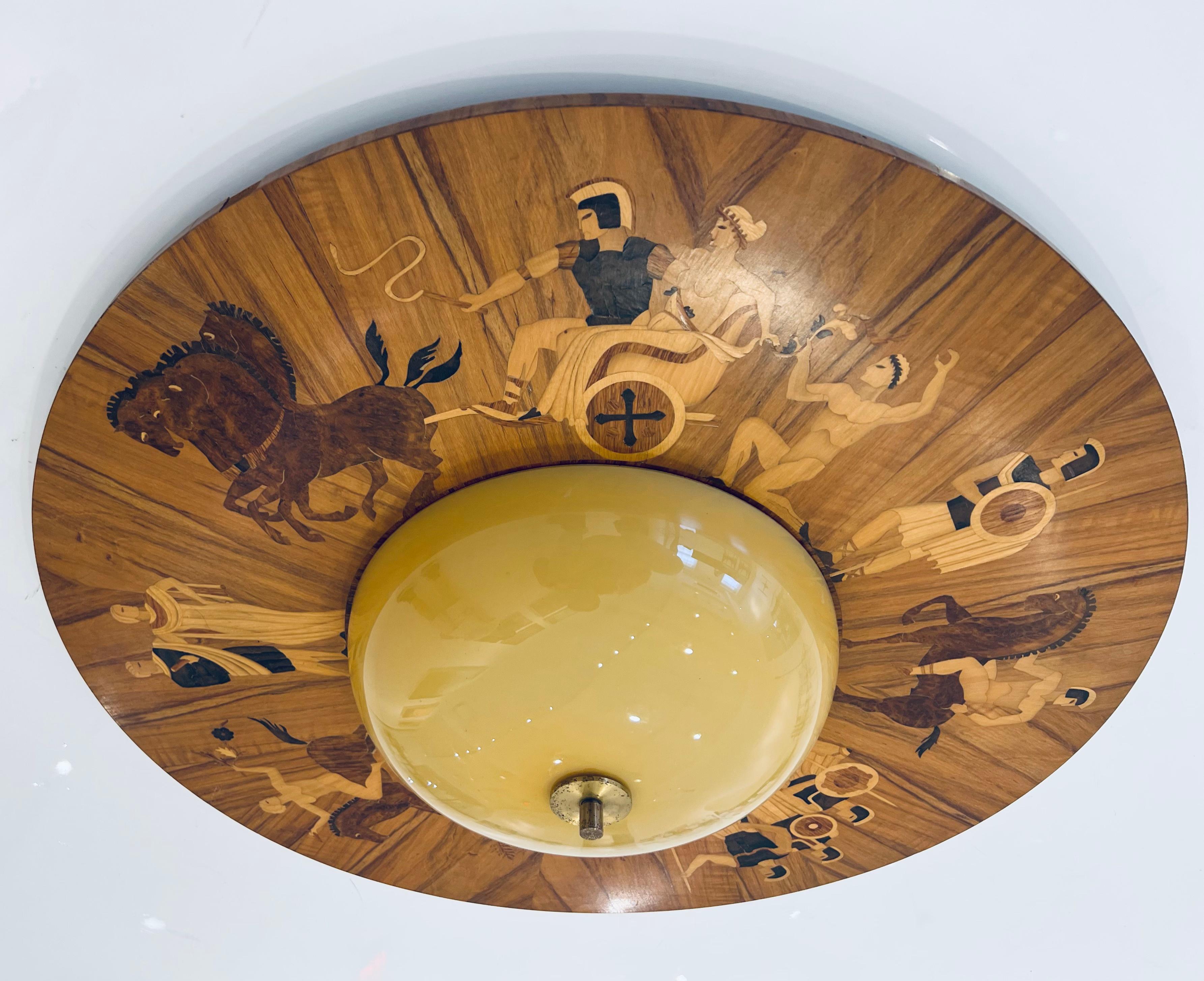 A rare 1920 Art Deco inlaid flush mount ceiling fixture by Birger Ekman for Mjolby Intarsia. The fixture has six standard base sockets. The inlaid wood portrays Roman scenes and has a large custard dome glass shade with aged brass finial. Rewired.