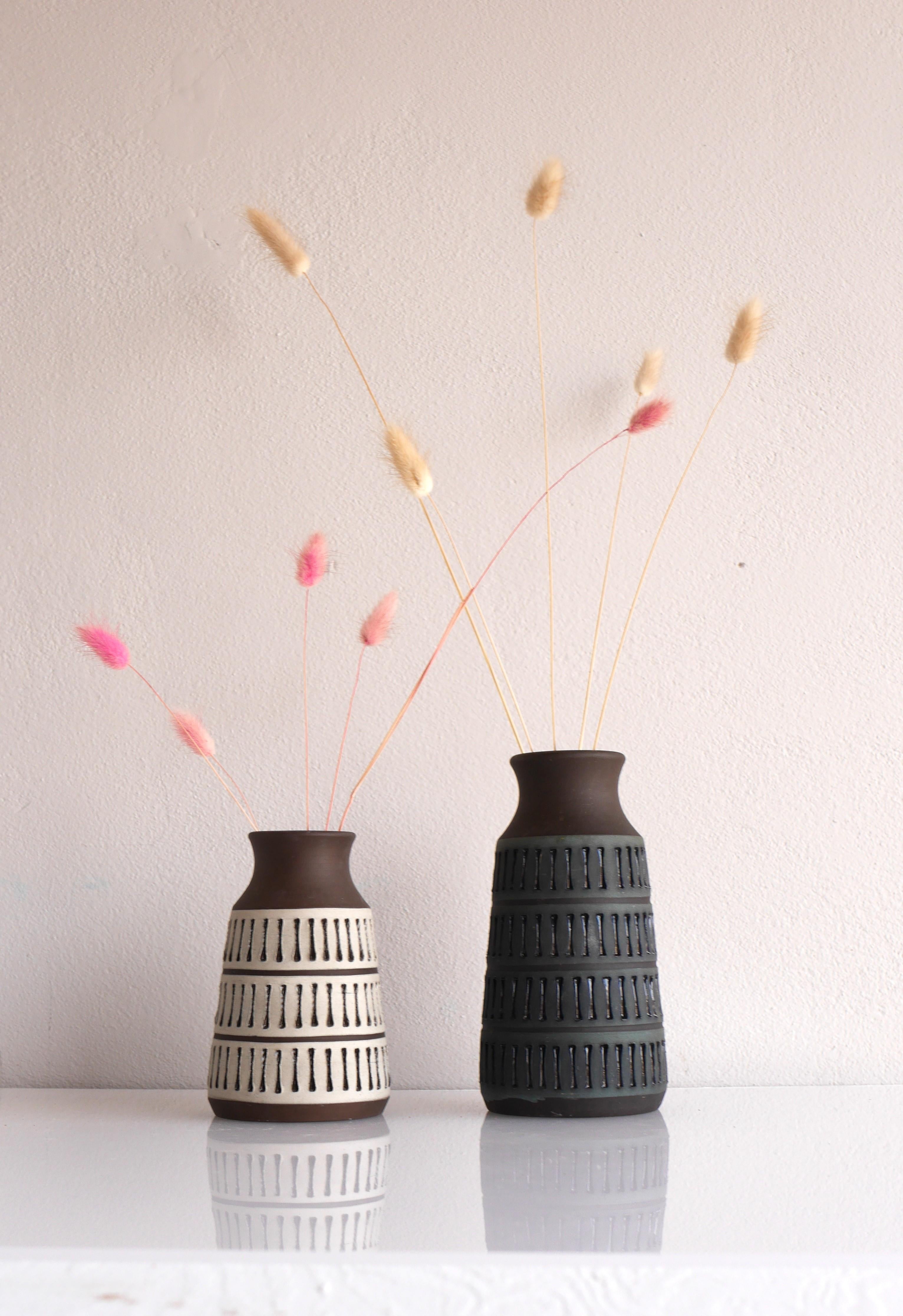 A fantastic pair of vintage brutalist art ceramic vase, handmade and design by Thomas Anagrius, for Alingsås Keramik, Sweden. These vases have a simple but effectful design with imprints and a nonglossy glazing. It is s the simple shape, color of