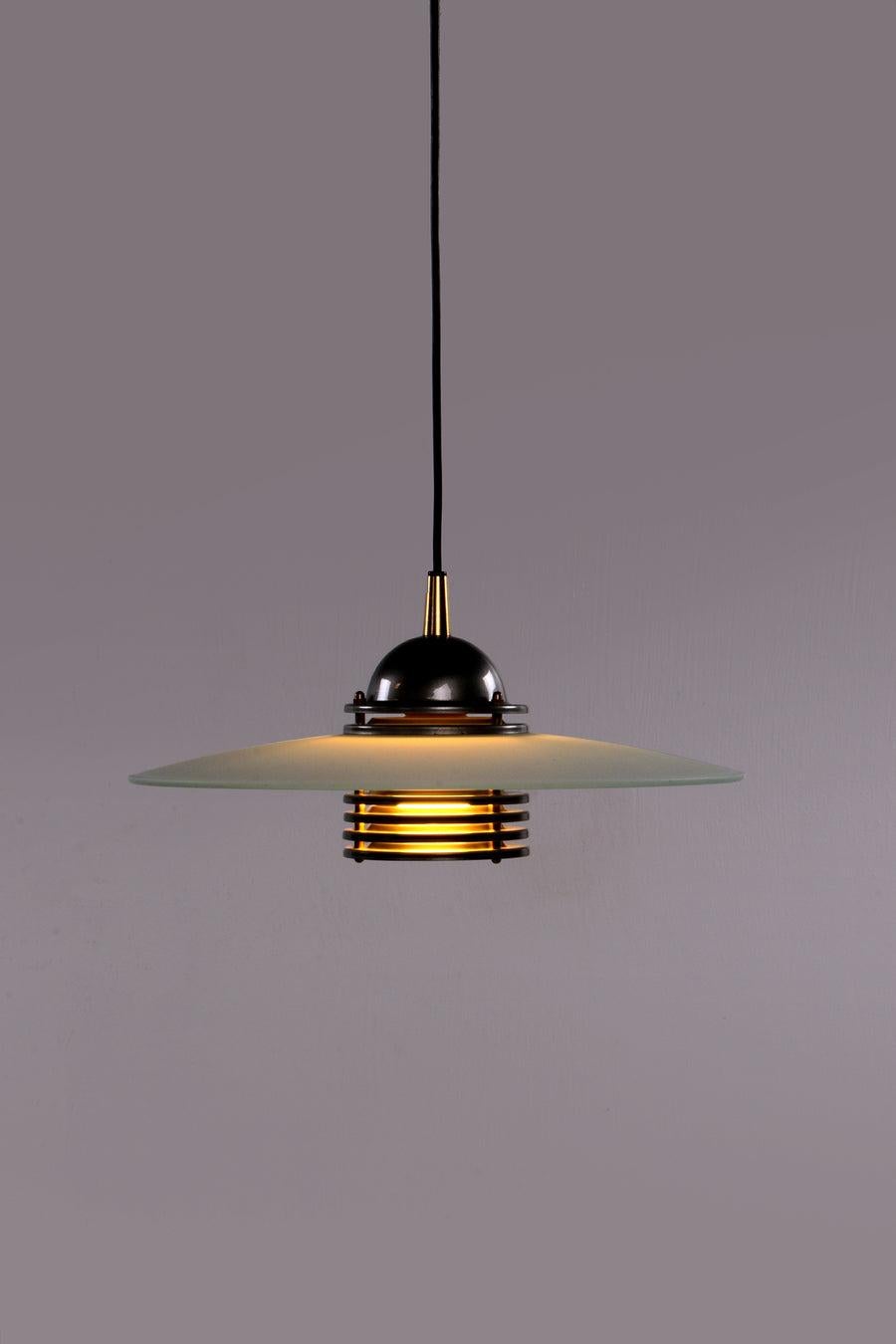 Swedish Design Pendant Lamp by the Brand Belid, 1960

This postmodern pendant was designed by Belid, Sweden.
It has a frosted glass shade, a metal shade, and a beautiful bottom.

Sustainable: environmentally conscious By supplementing your interior