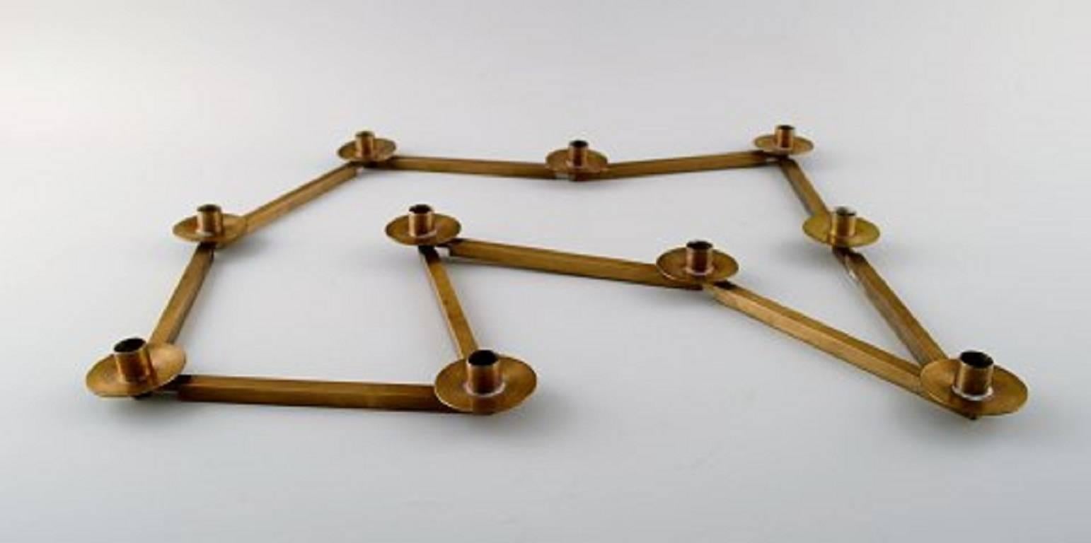 Swedish design table candlestick for ten lights in brass, jointed. 1950s-1960s.
Measures: 60 cm long, 2 cm high.
In perfect condition.
Unstamped.