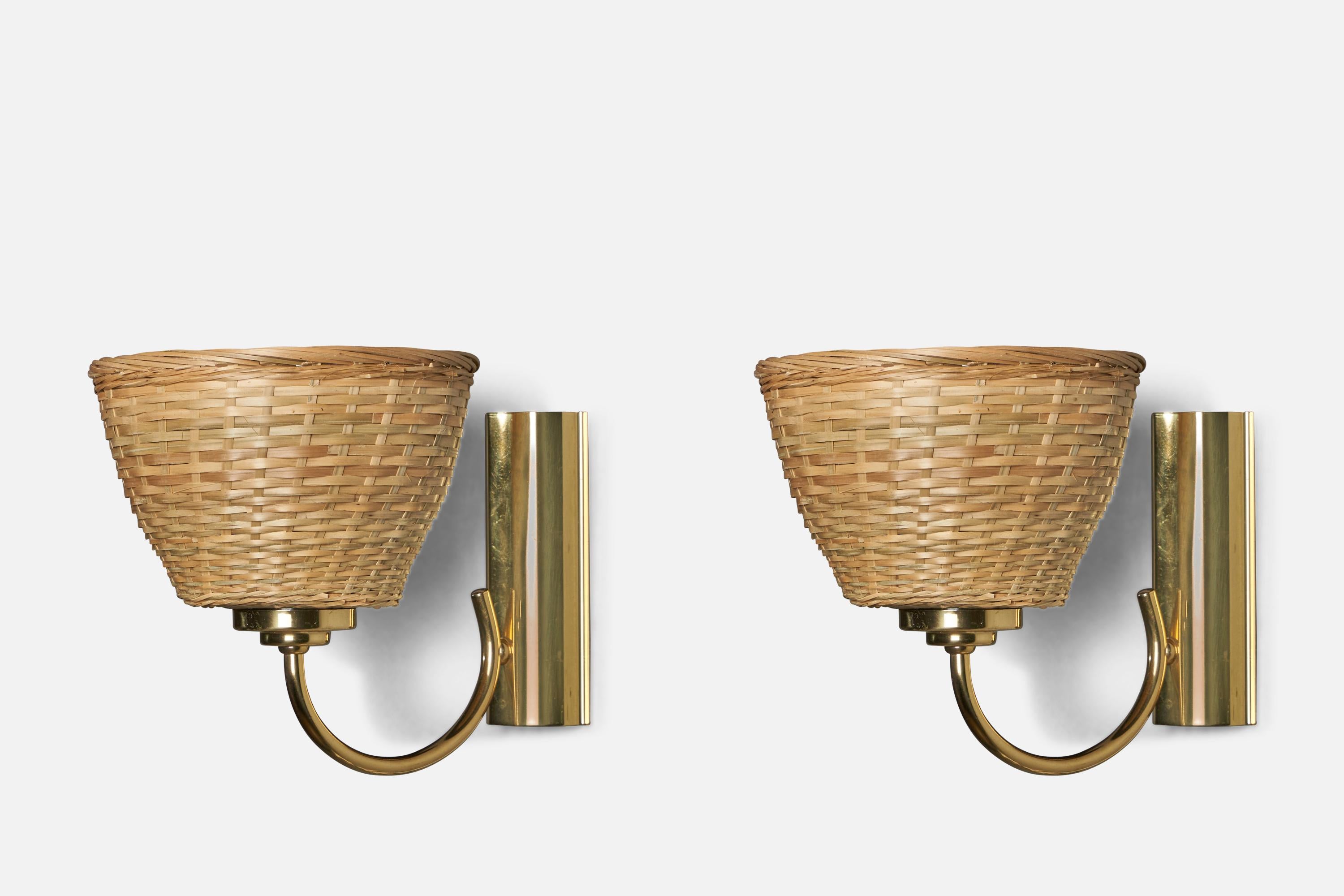  A pair of brass and rattan wall lights designed and produced in Sweden, 1970s.

Overall Dimensions (inches): 8.25” H x 7” W x 10” D
Back Plate Dimensions (inches): 6” H x 2.5” W x 1.25” D
Bulb Specifications: E-26 Bulb
Number of Sockets: 1