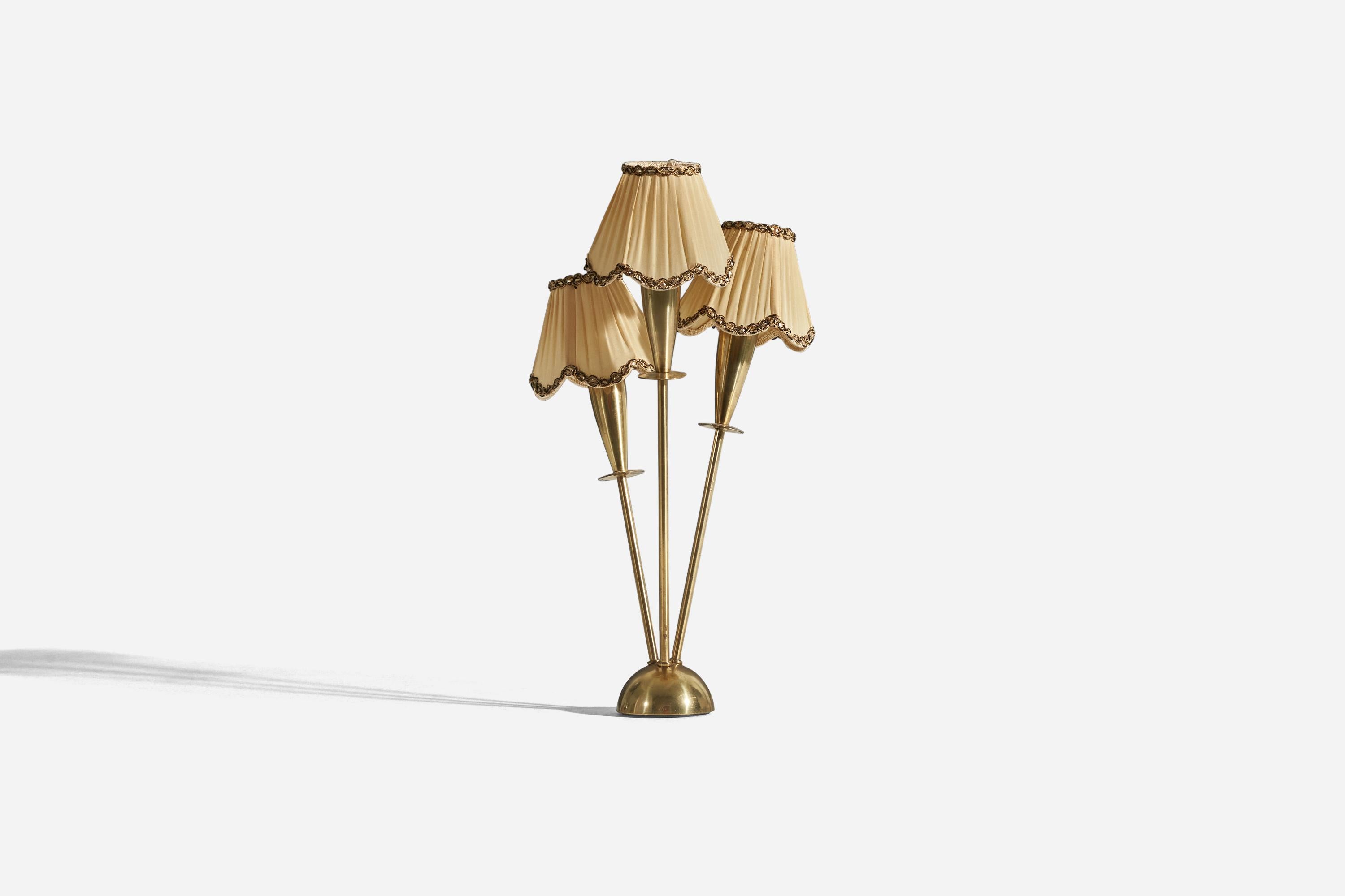 A 3-light brass and fabric table lamp designed and produced in Sweden, c. 1940s. 

Sold with lampshades. 
Stated dimensions refer to the lamp with the shades.
