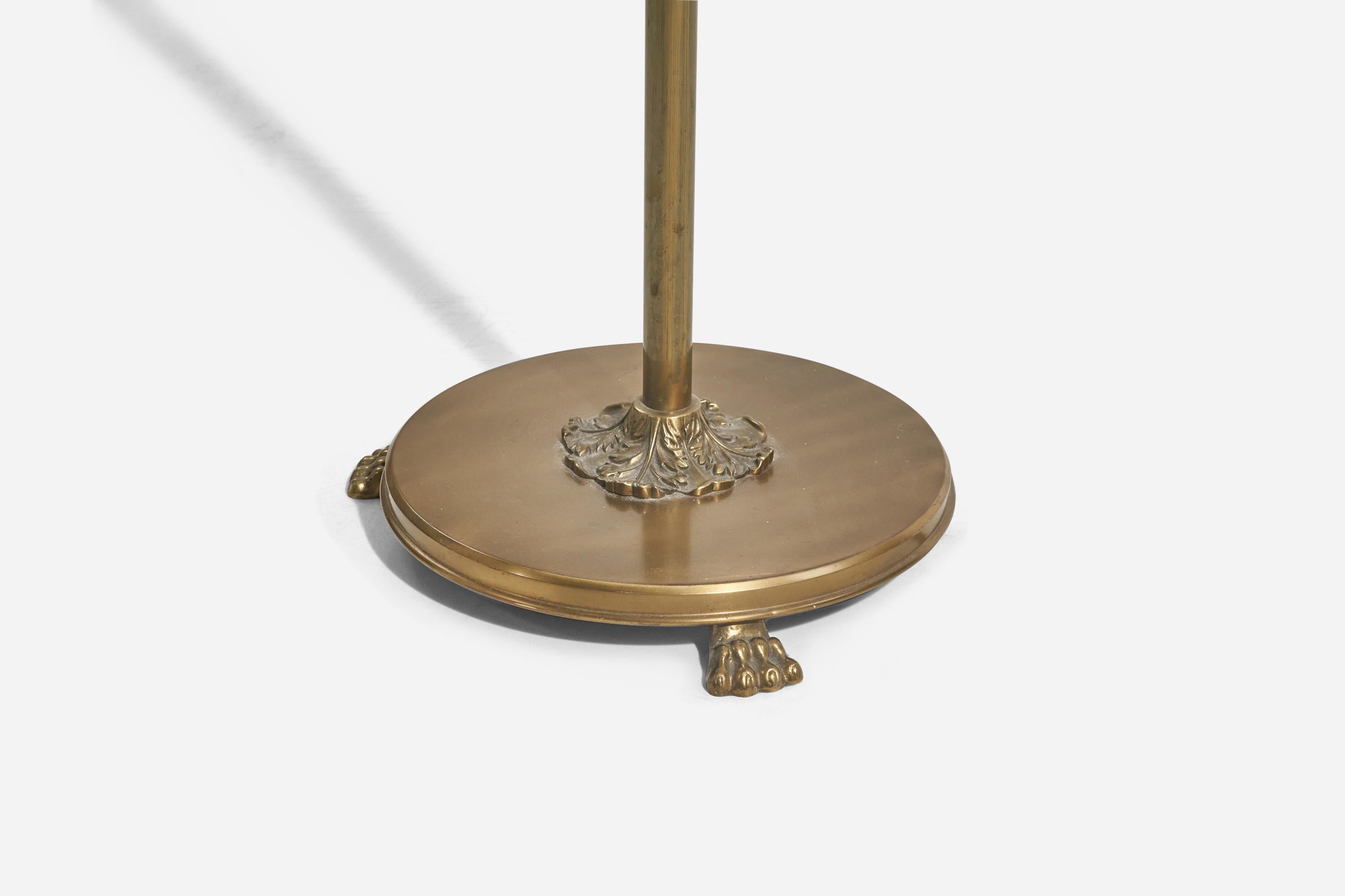 A brass and rattan floor lamp designed and produced by a Swedish designer, Sweden, 1940s. 

Dimensions variable, measured as illustrated in first image.

Sold with Lampshade(s). Dimensions stated are of Floor Lamp with Shade(s). 

Socket takes