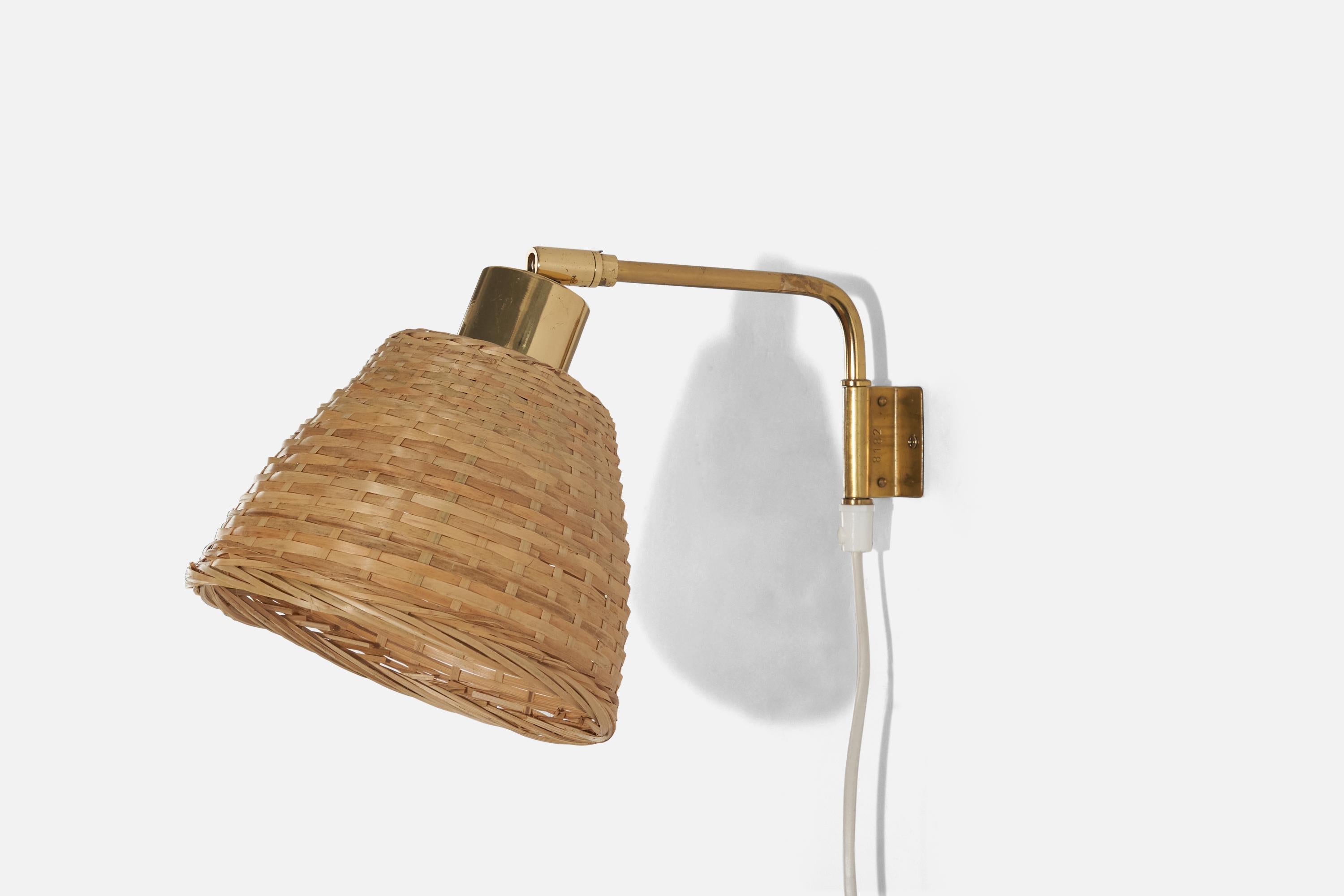 A brass and rattan, adjustable sconce designed and produced in Sweden, c. 1960s. 

Variable dimensions, measured as illustrated in the first image.
Dimensions of back plate (inches) : 1.97 x 1.62 x 0.05 (height x width x depth).

Socket takes