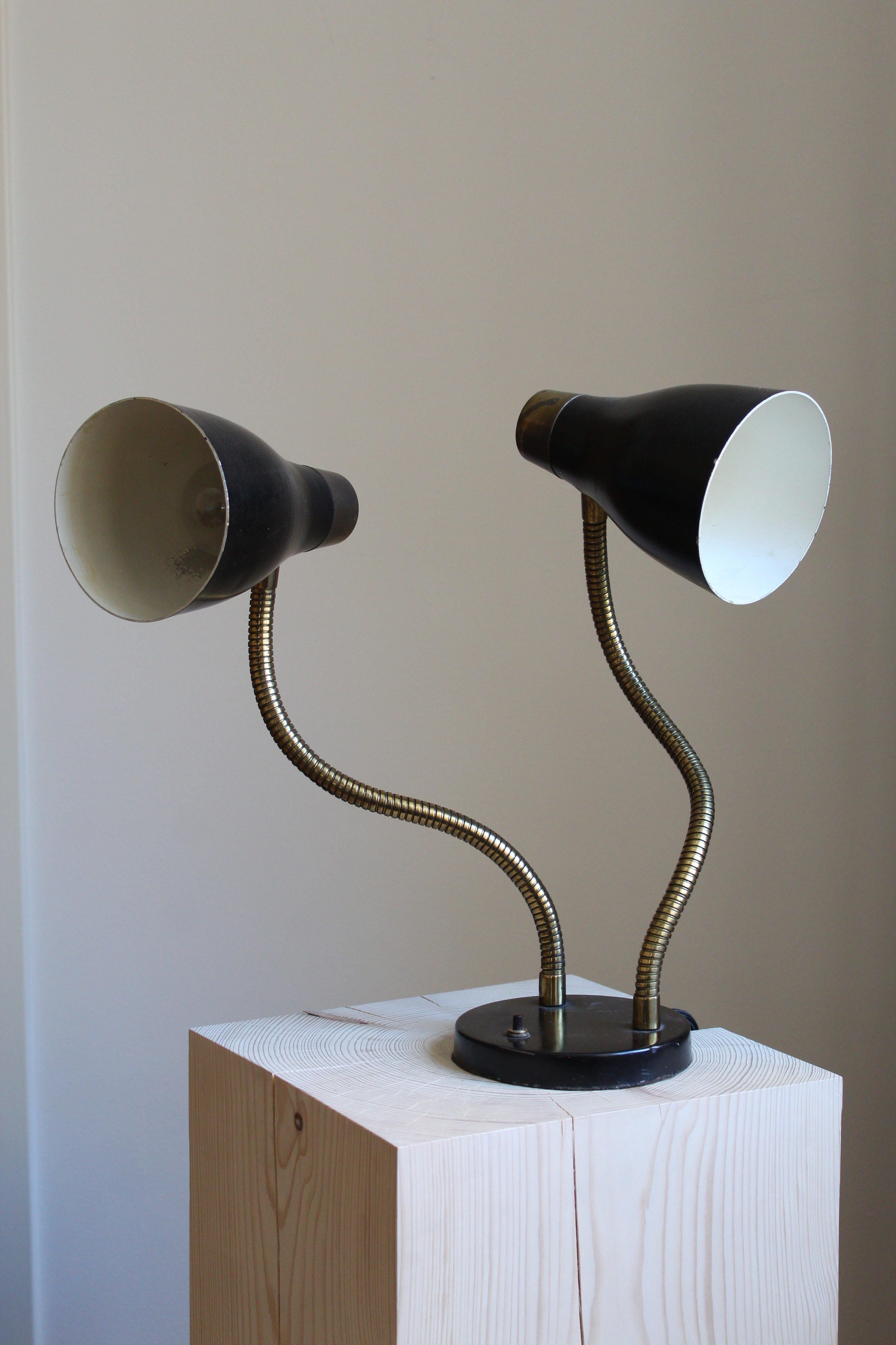 An adjustable table lamp. Designed and produced in Sweden, 1950s. Lacquered metal and brass. 

Other designers of the period include Serge Mouille, Lisa Johansson-Pape, Greta Magnusson Grossman, and Paavo Tynell.