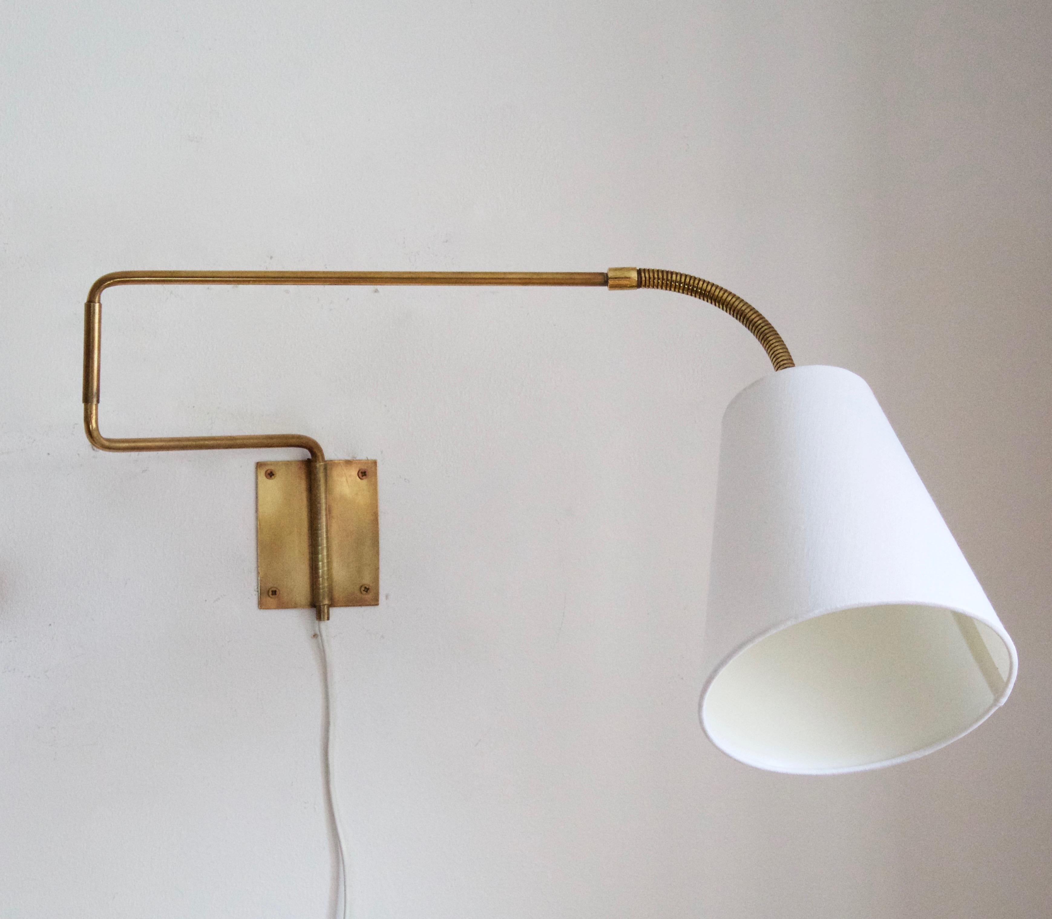 A functionalist wall light / task light, designed and produced in Sweden, 1940s-1950s. Features brass. Fabric lampshade. Adjustable.

Stated dimensions with lampshade attached as is illustrated in the primary image.

  