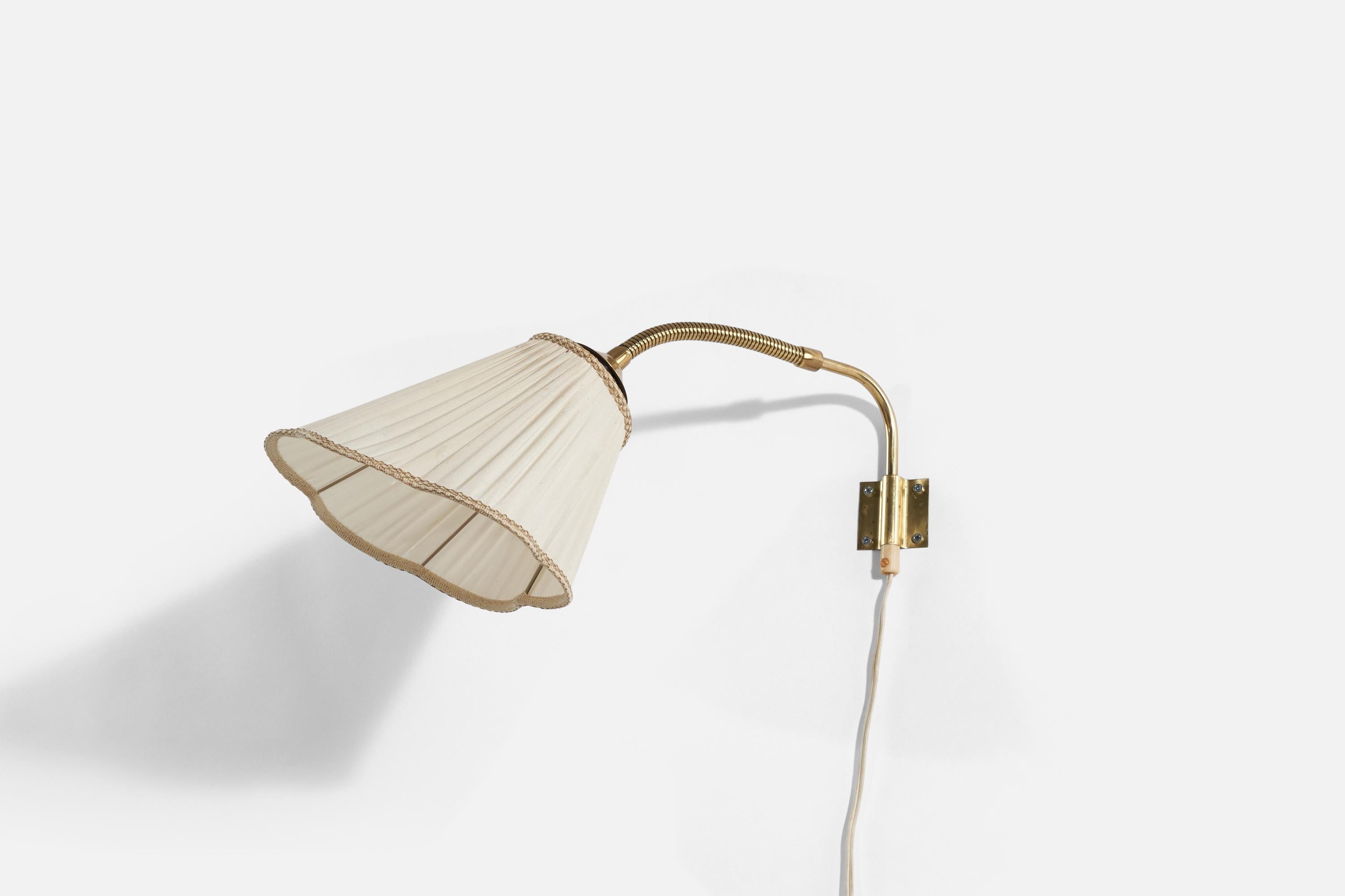 A brass and fabric wall light produced in Sweden, 1940s-1950s.