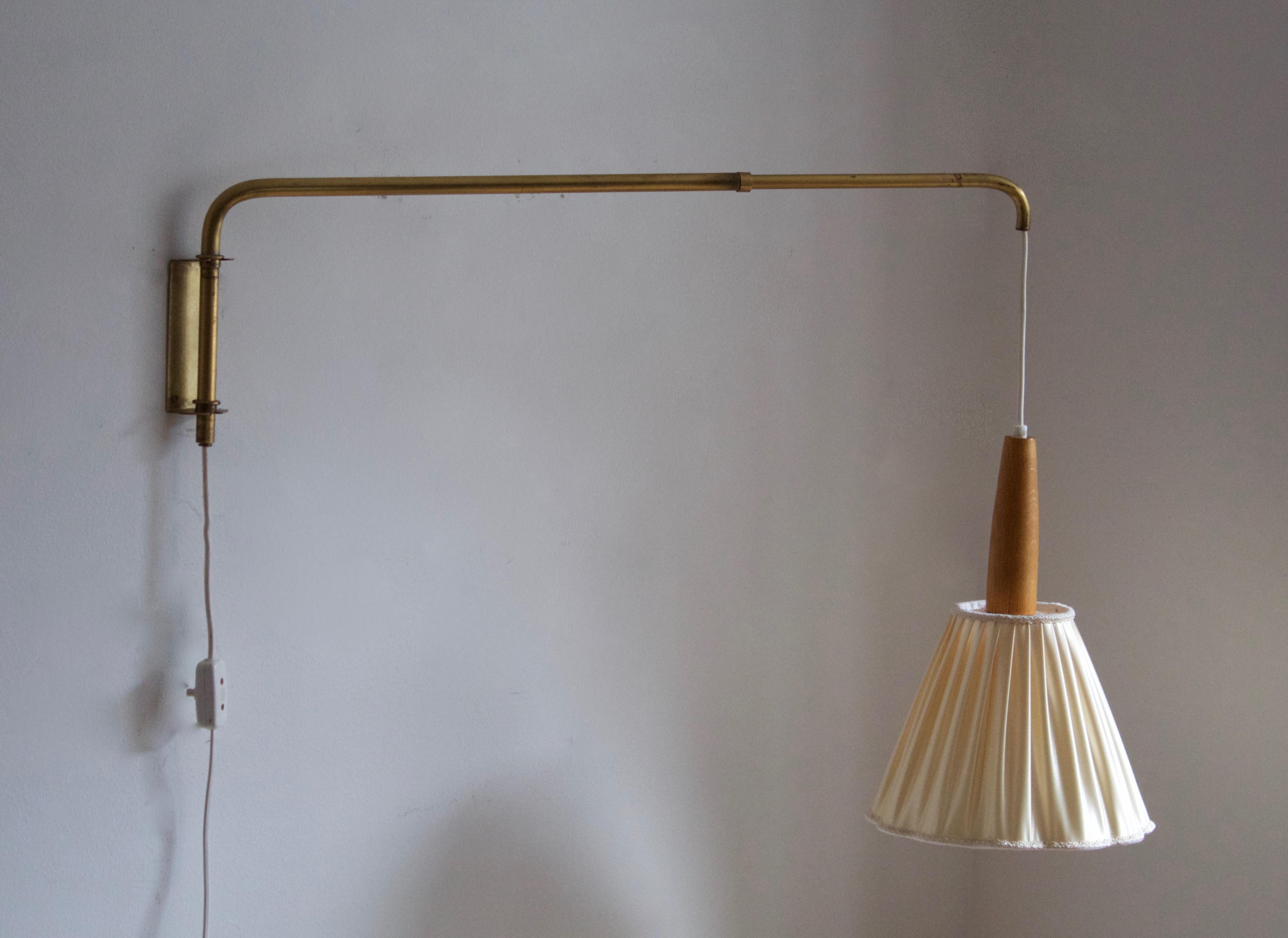 A functionalist wall light / task light, designed and produced in Sweden, 1940s-1950s. Features brass. Fabric lampshade. Adjustable.

Stated dimensions with lampshade attached as is illustrated in the primary image.

  