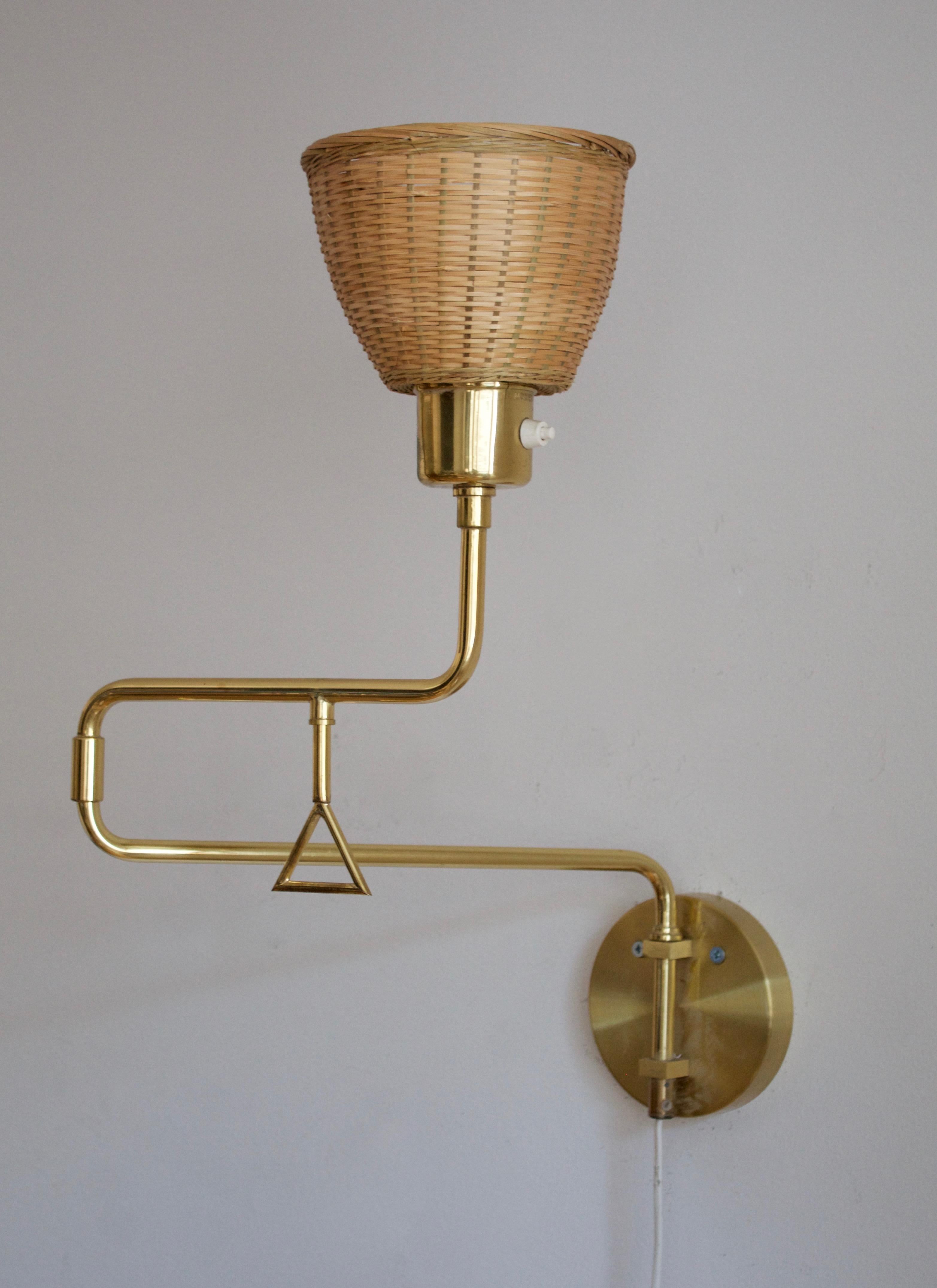 A wall light, designed and produced in Sweden, c. 1970s. Features brass, assorted vintage lampshade.

Stated dimensions with lampshade attached.