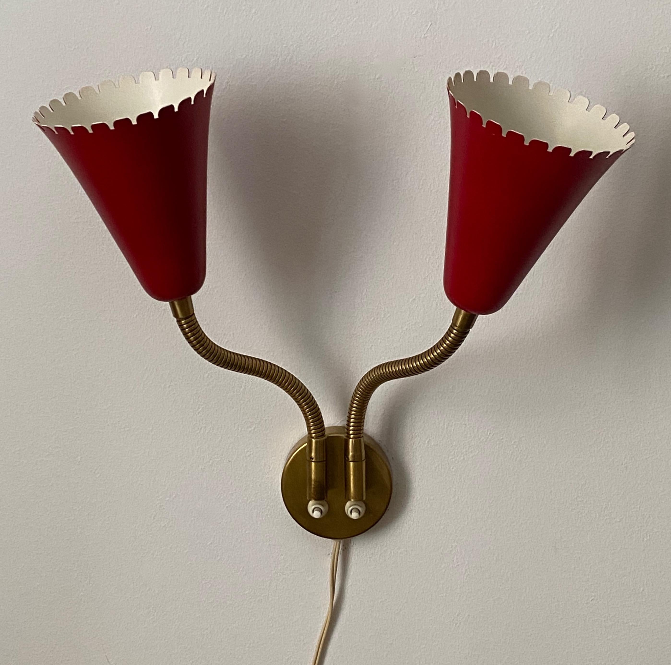 An adjustable organic wall light / sconce. Designed and produced in Sweden, 1950s. In brass and red-lacquered metal. Markings indicate patented design. 

Other designers of the period include Jean Royere, Paolo Buffa, Gino Sarfatti, Hans