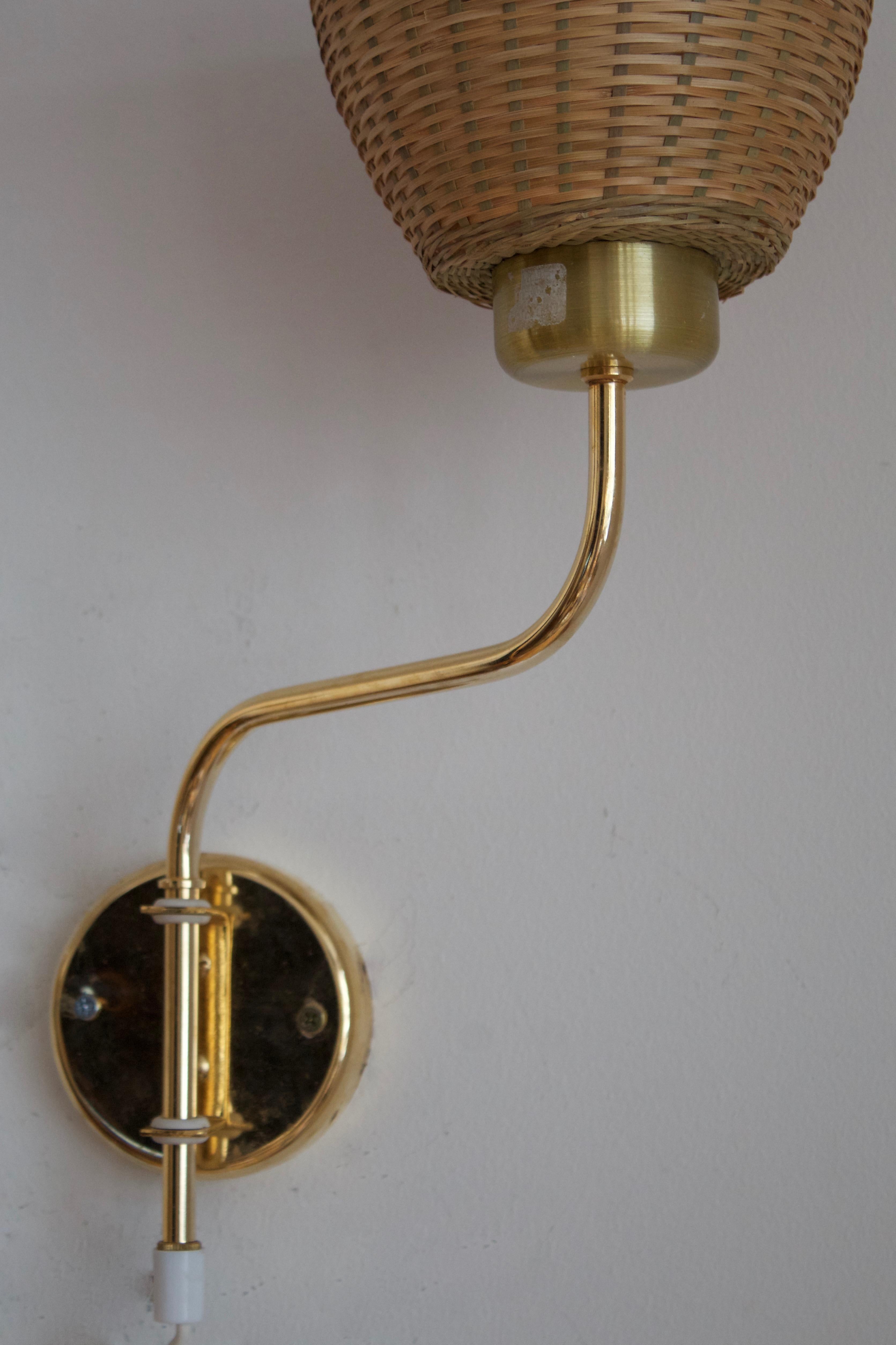 Swedish Designer, Adjustable Wall Lights, Brass, Rattan, Sweden, 1970s In Good Condition In High Point, NC