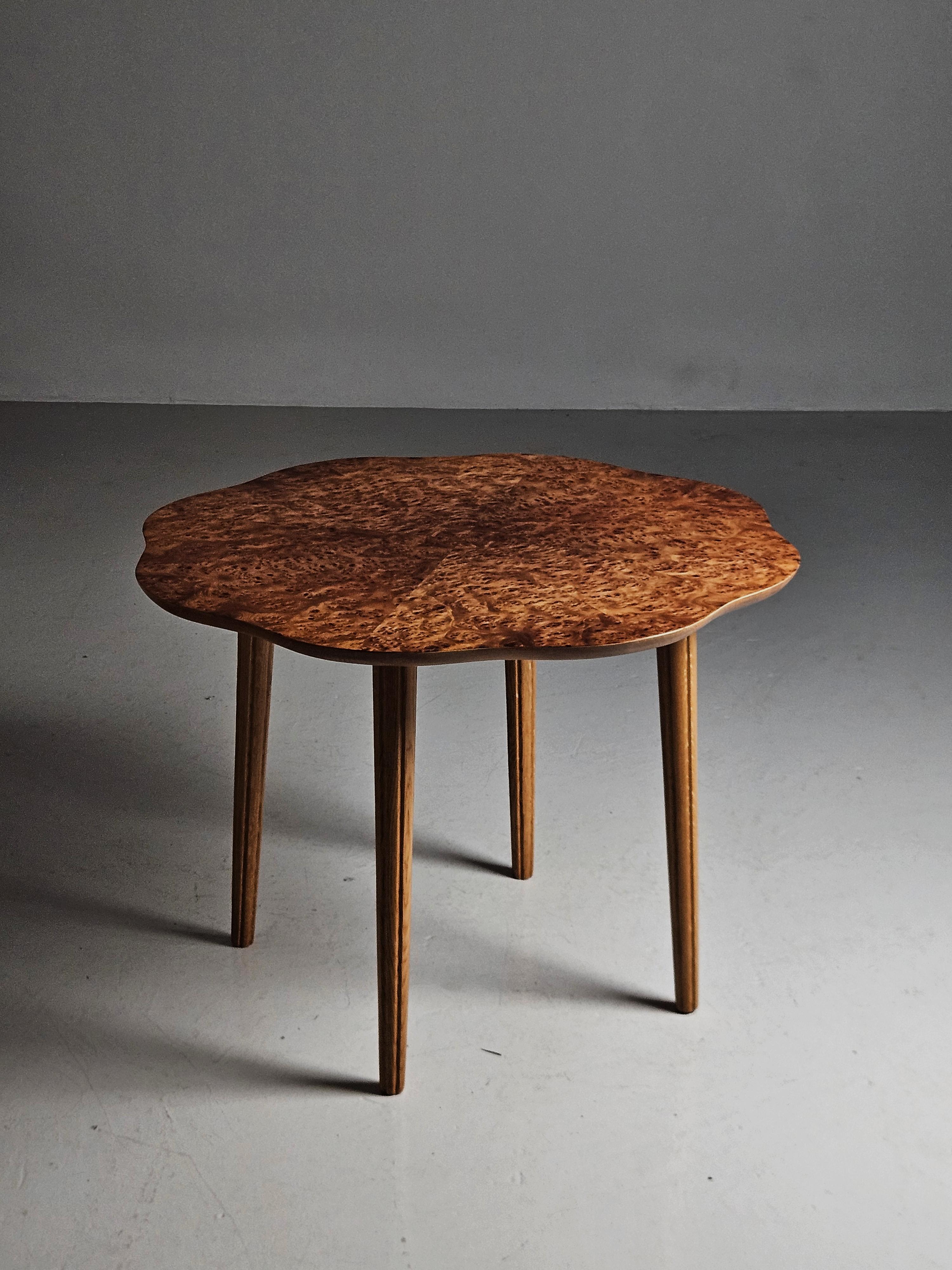 Elegant coffee or side table made by unknown Swedish designer in the 1940s. 

Alder root table top with four slender legs. Lovely wavy form on the table top. 
